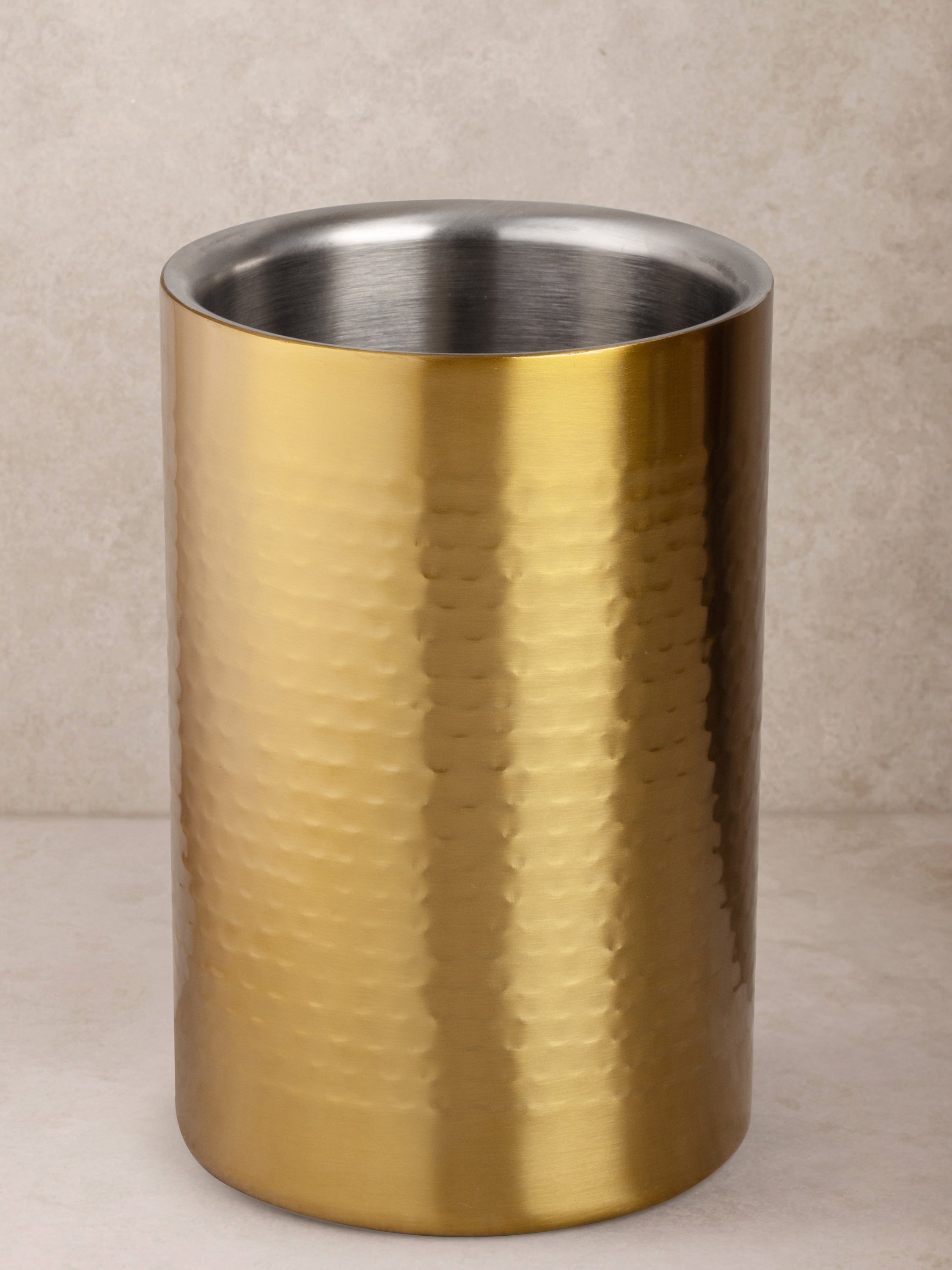 Hand-crafted matte gold wine cooler with dimpled stainless-steel texture — artisan bar accent