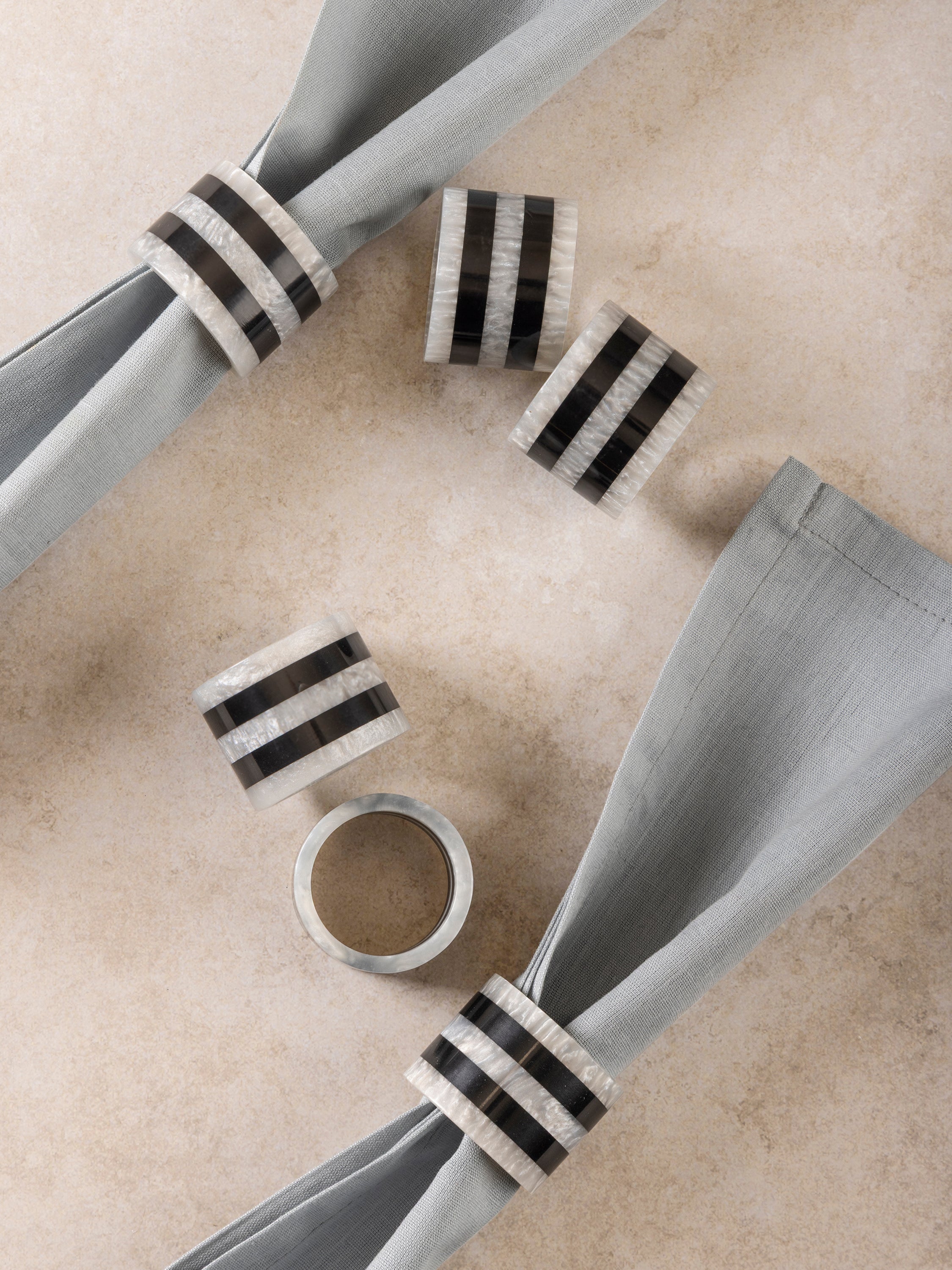 Set of six polished resin napkin rings featuring elegant color contrast and refined texture — refined home dining detail