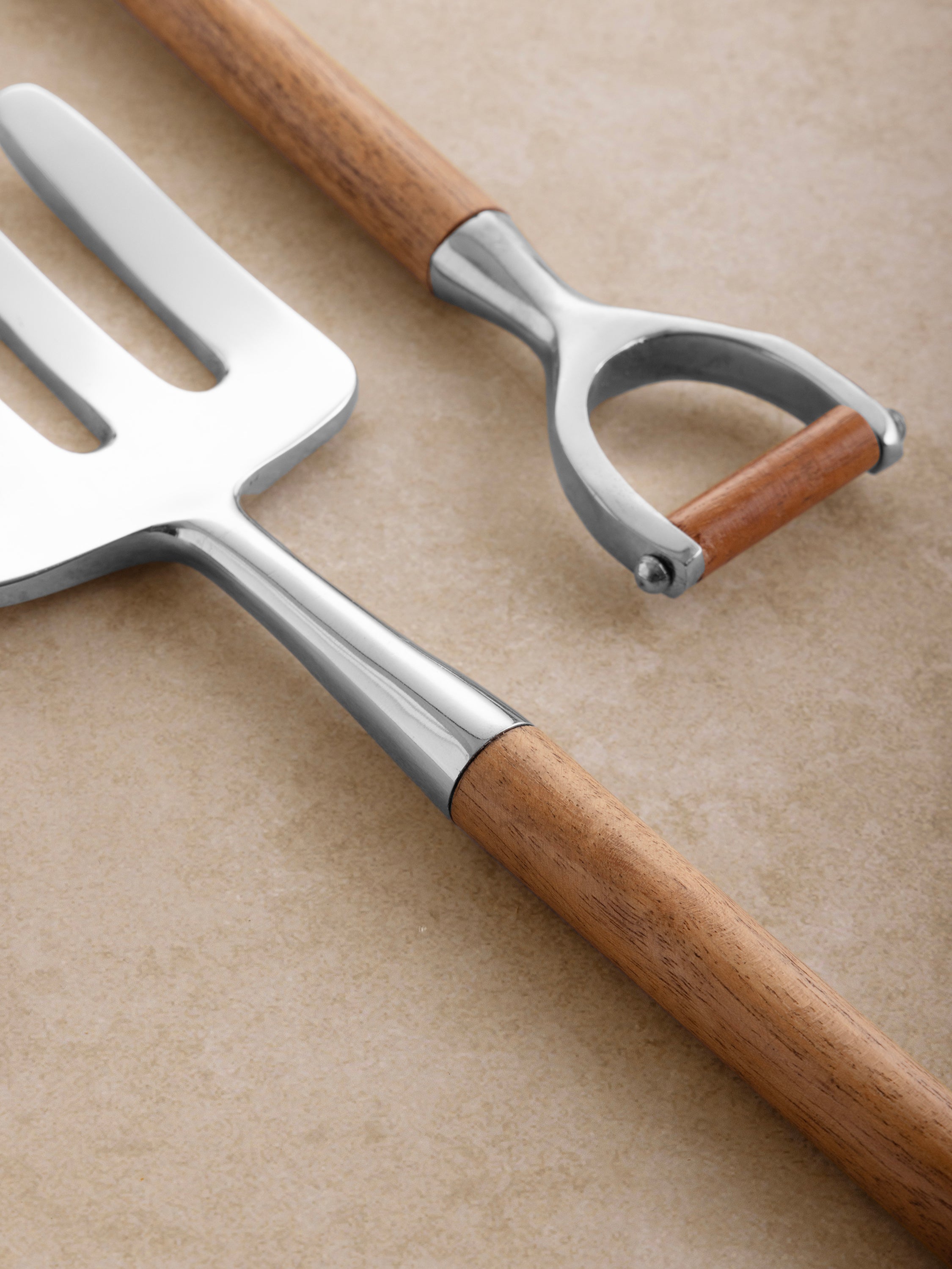 Polished silver salad servers with wood handles — artisan-made for modern entertaining