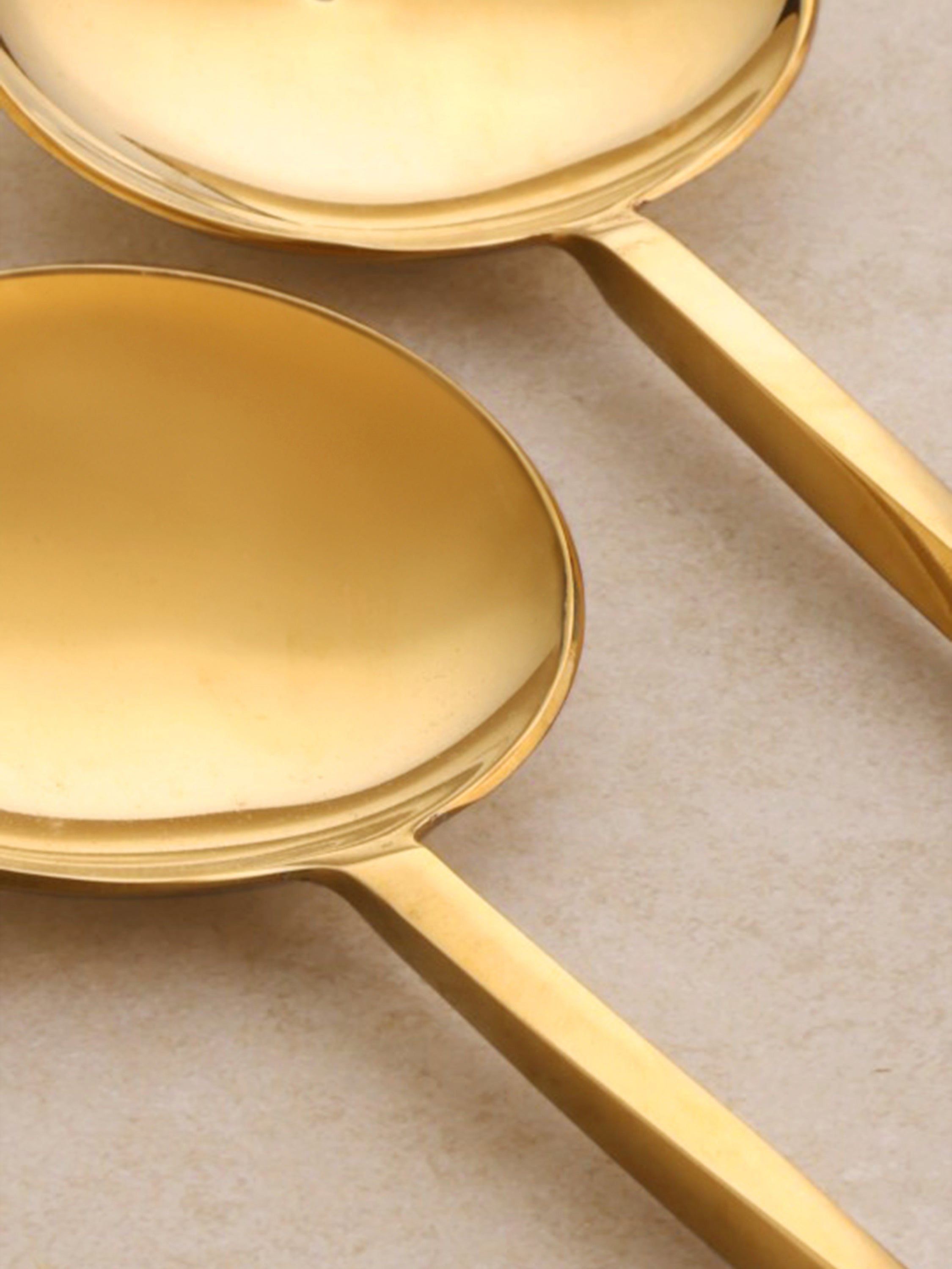 Close-up of the Oslo servers showing smooth rounded brass heads and polished surface finish.
