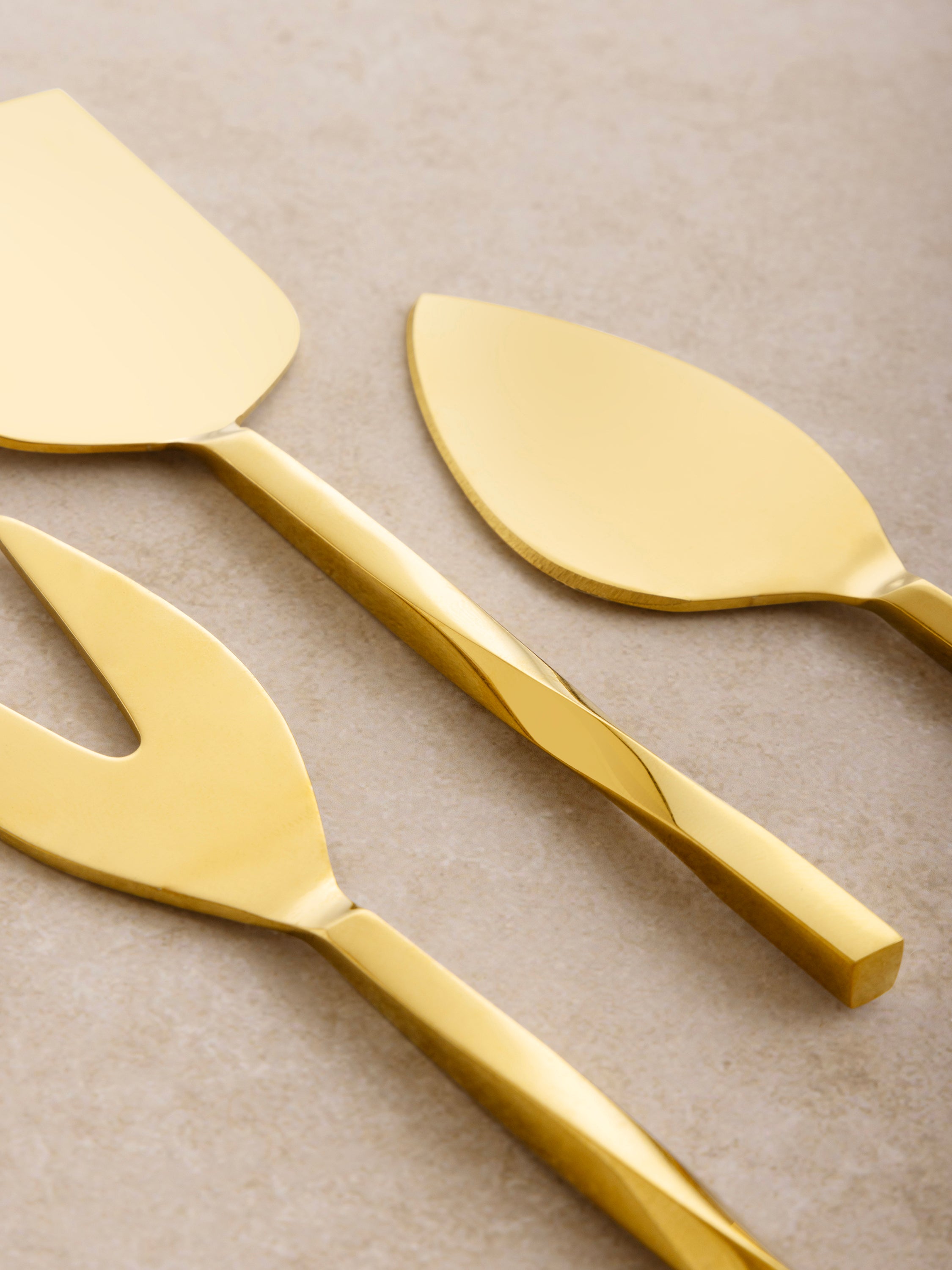 Gold cheese knives set of three with textured handle detail — timeless entertaining piece