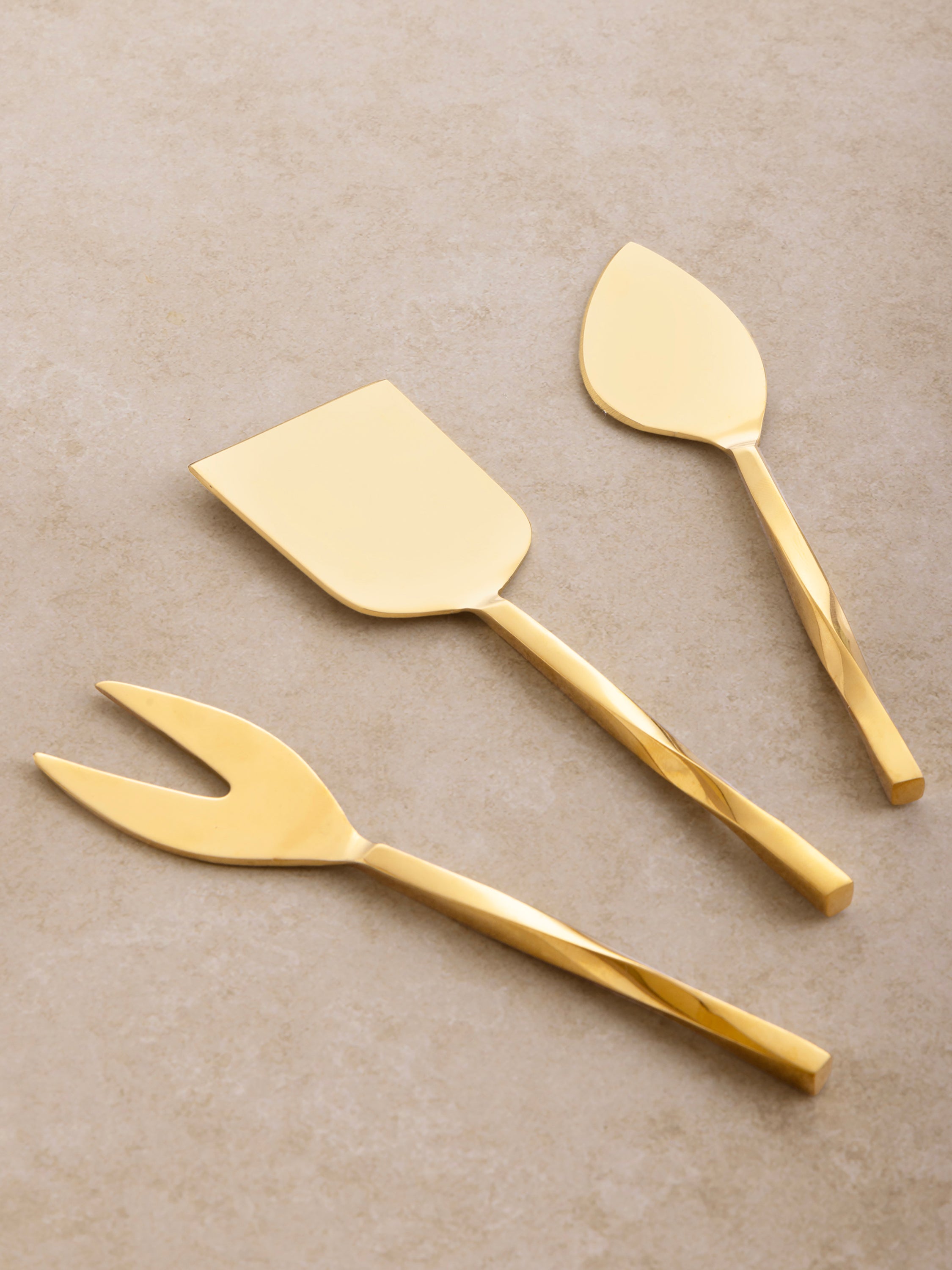 Elegant gold cheese knife trio with spiraled grip design — upscale cheese board tool