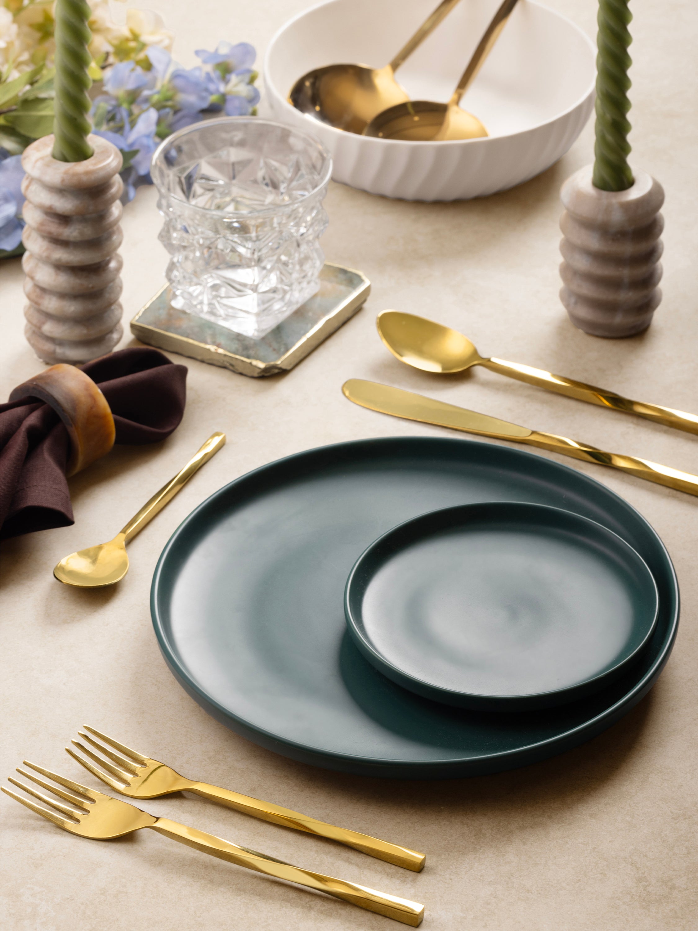 Five-piece gold flatware set with sculptural handles — refined dining accessory