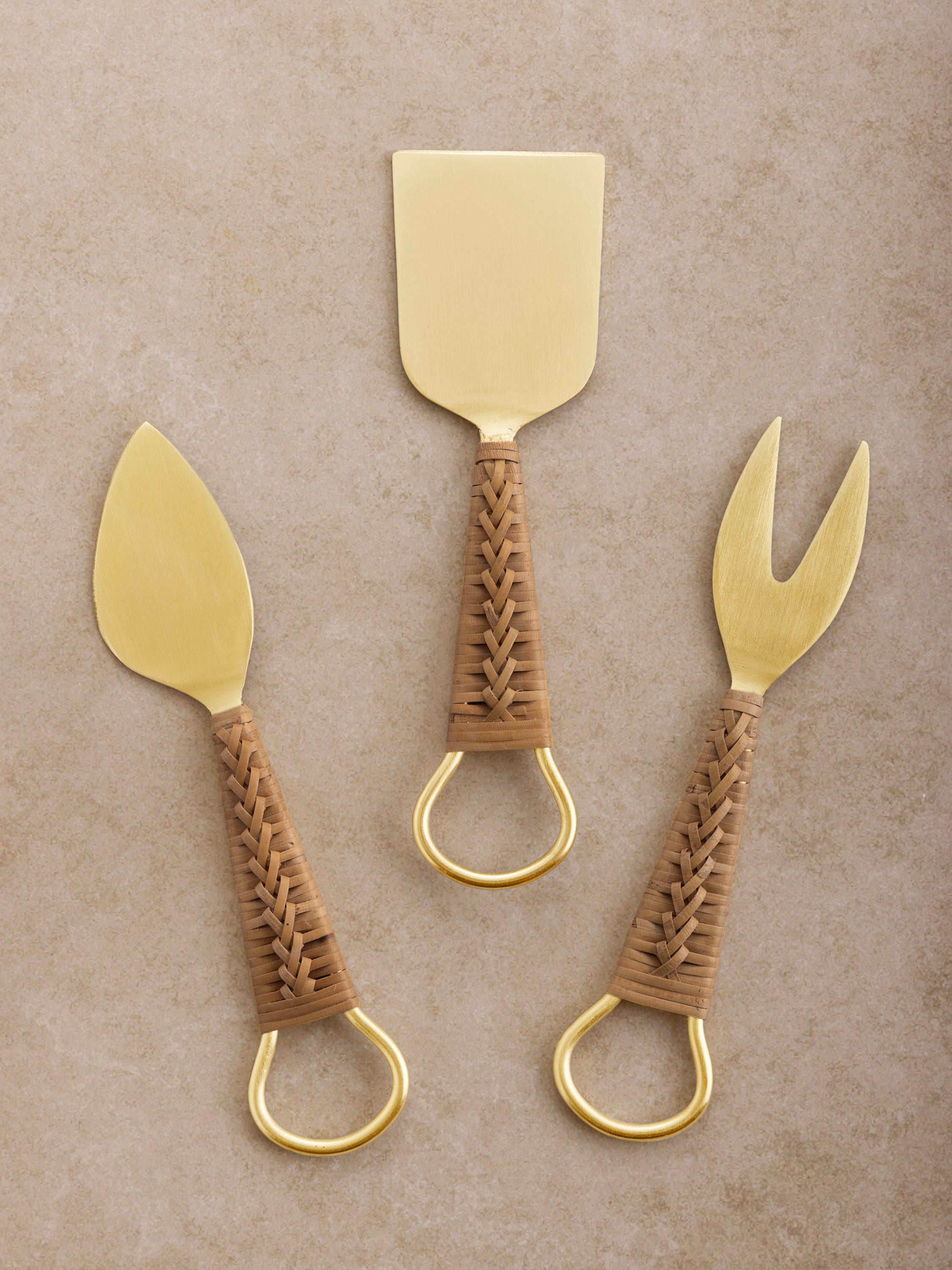 Matte gold cheese knives set of three with natural rattan handles — luxurious serveware