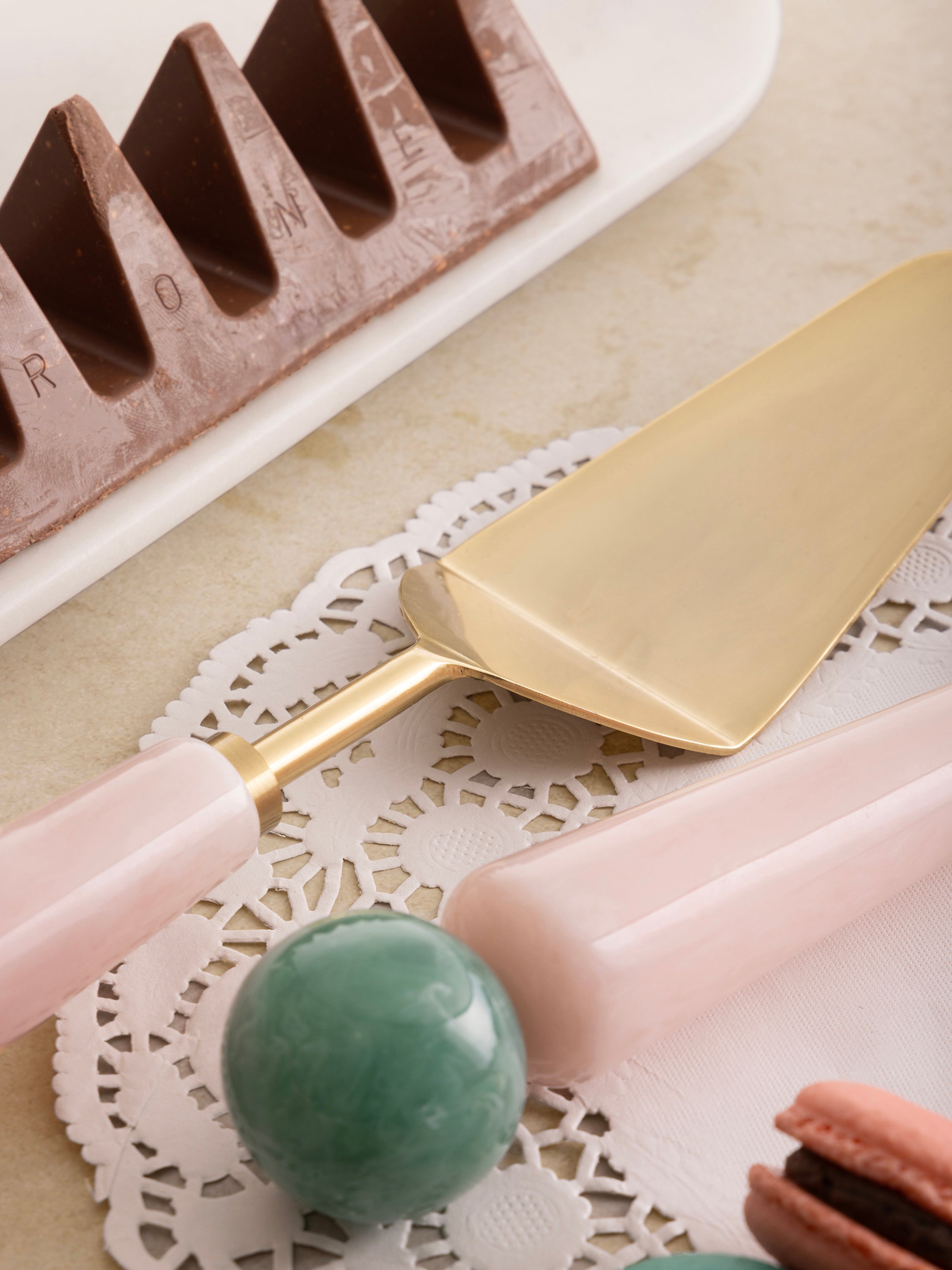 Blush pink and pastel green resin handle cake servers with gold heads — refined dining accessory