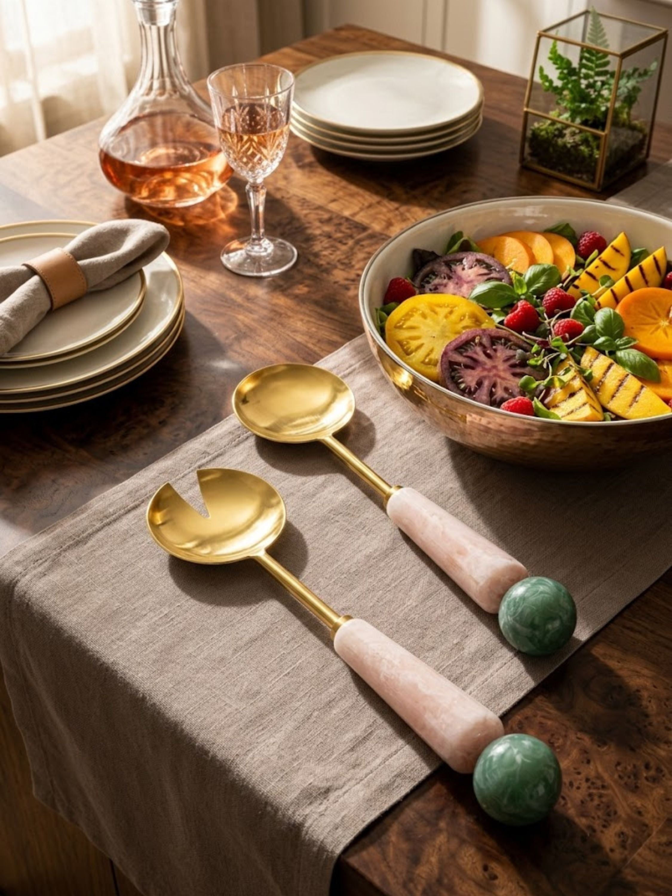 Copenhagen resin salad servers with blush handles and emerald sphere accents styled beside a vibrant serving bowl.