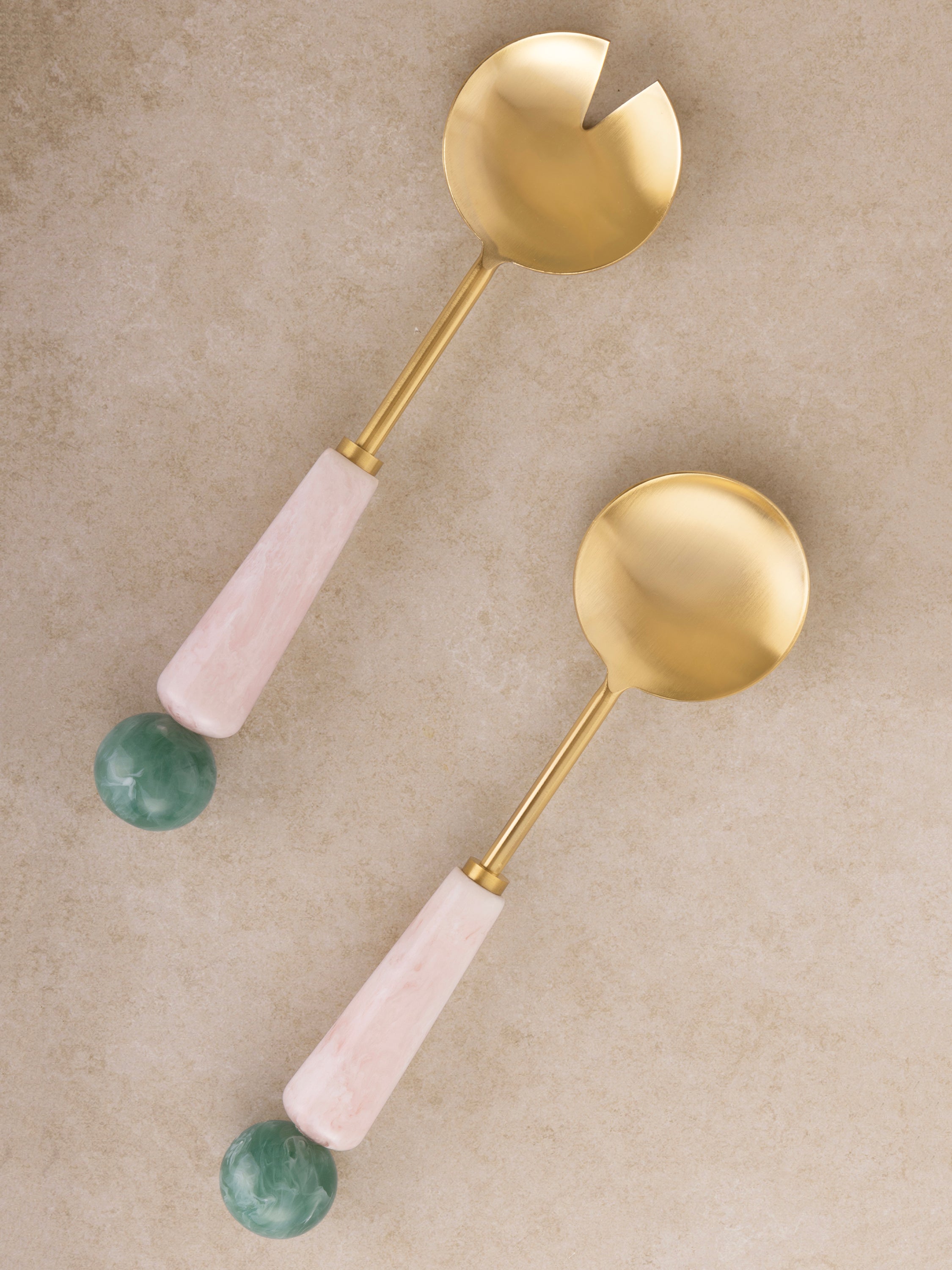 Matte gold salad servers with soft pink and green resin handles — elegant handcrafted serveware