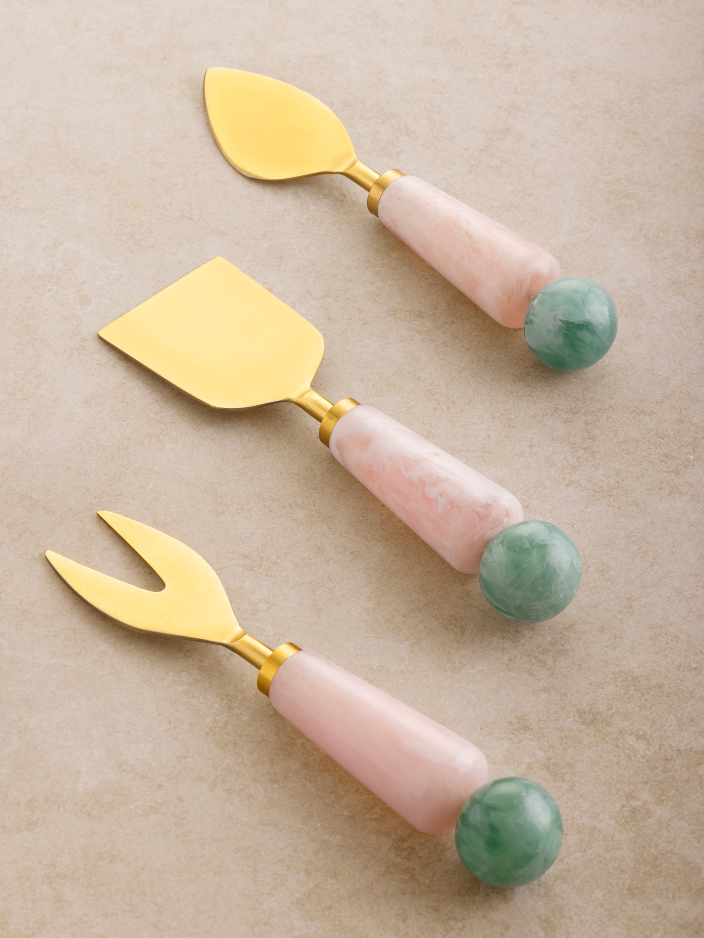 Copenhagen cheese knives in gold finish and pastel resin handles — luxury entertaining tool