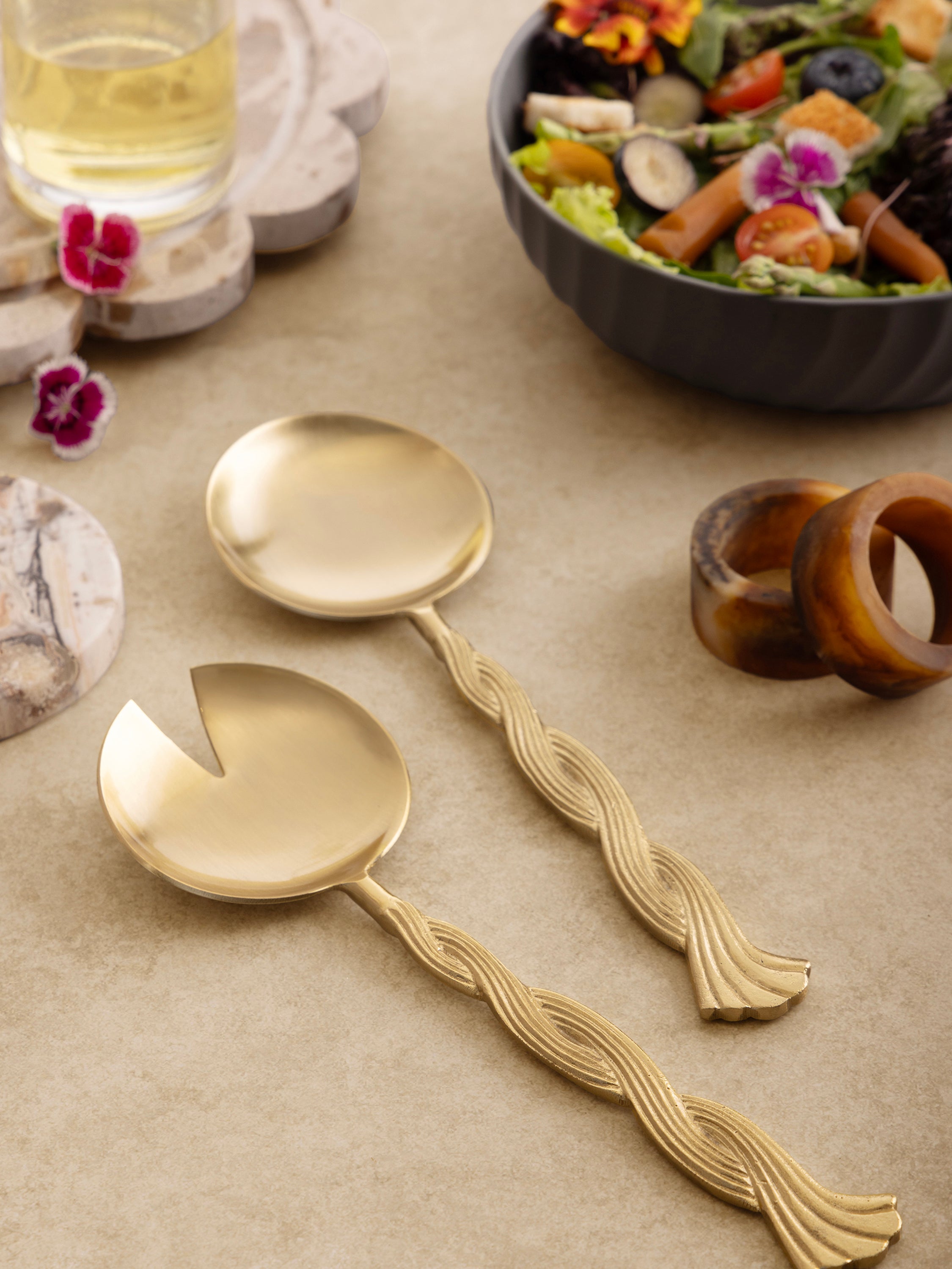 Gold salad spoon and fork with sculptural twisted handles — refined dining accent
