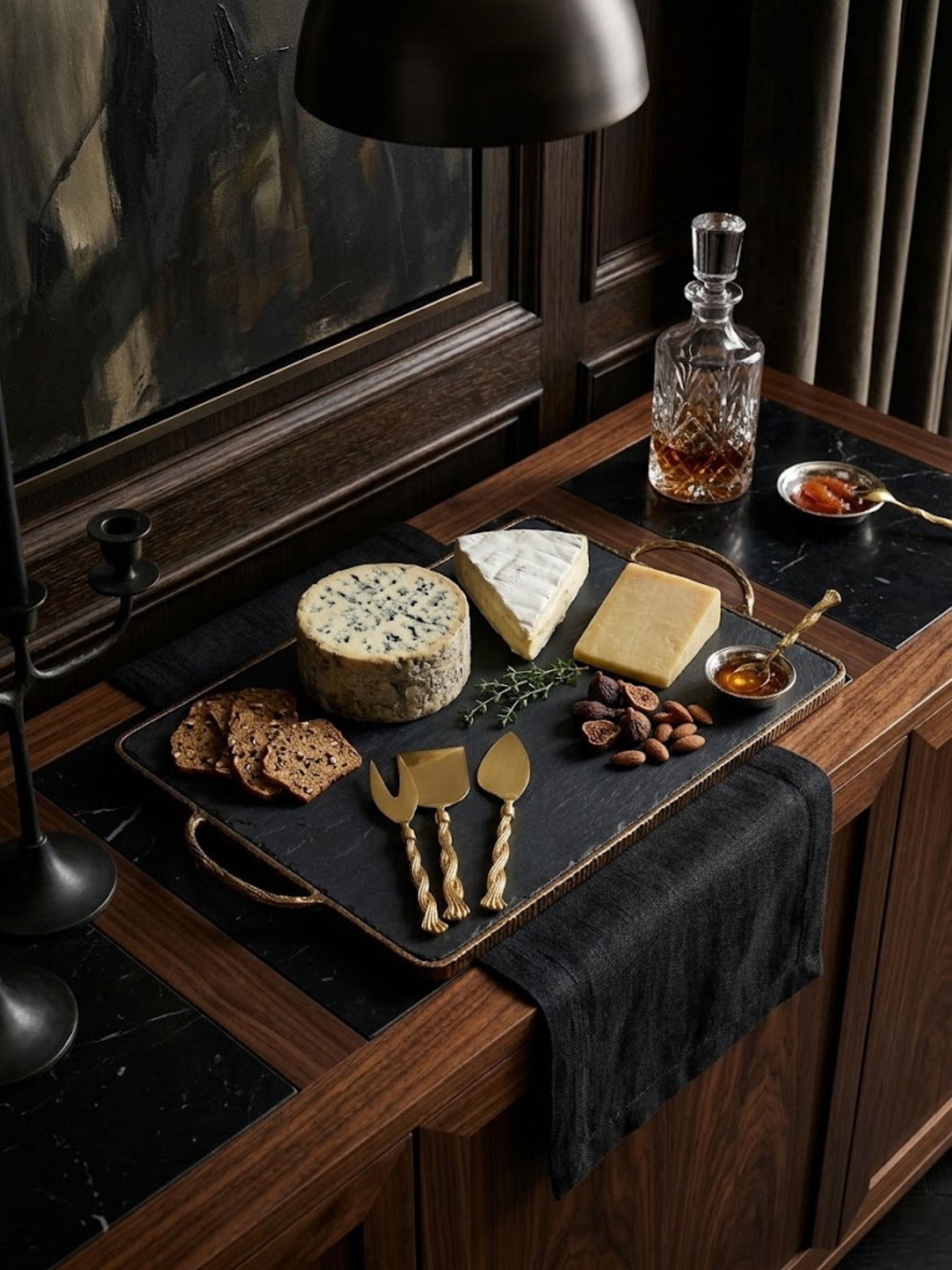 Santiago gold cheese knives styled in a wine cellar setting with curated cheeses and charcuterie, creating a tasting and serving experience.
