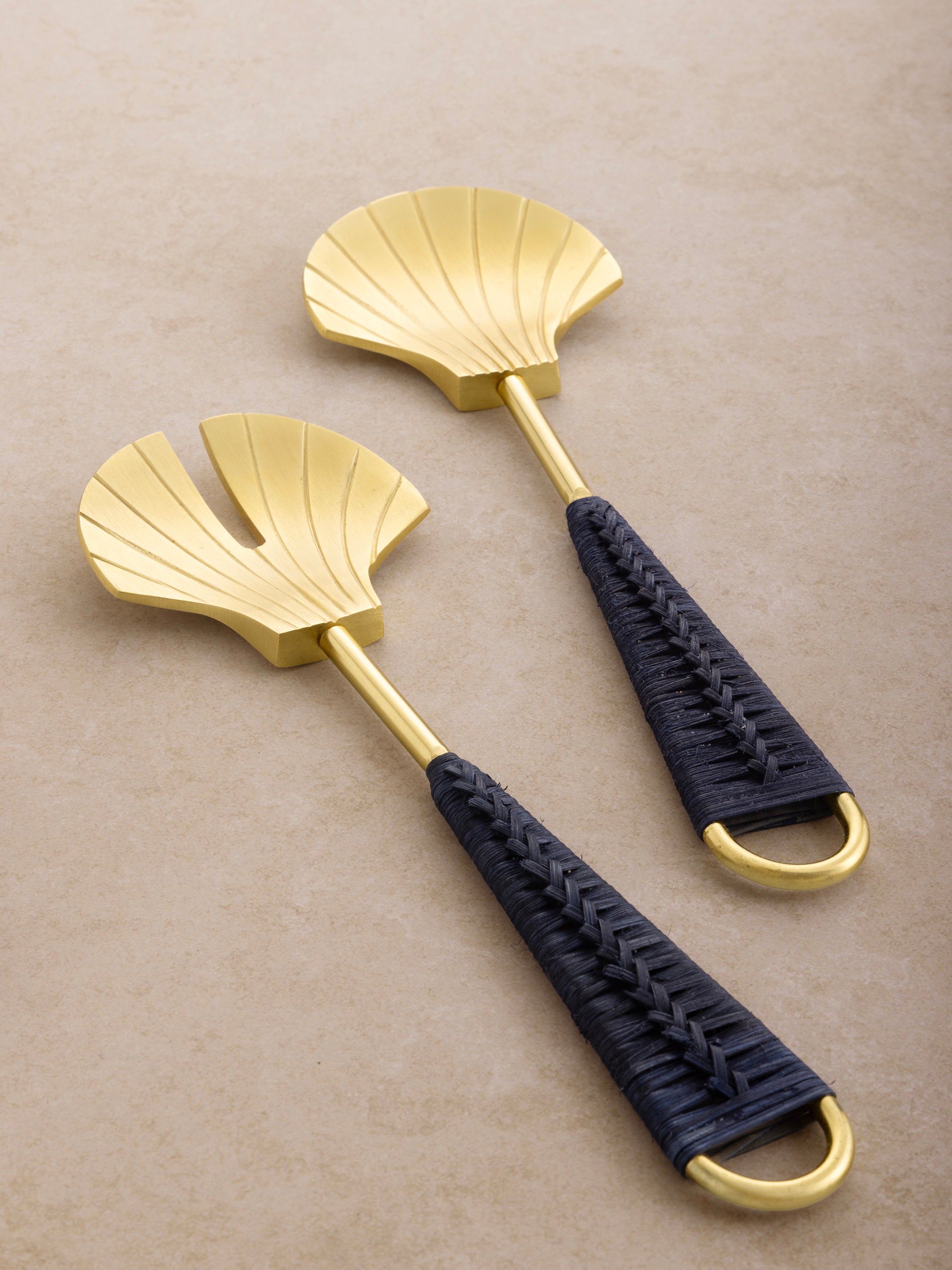 Gold salad serving spoon and fork with woven blue handles — nautical-inspired tableware