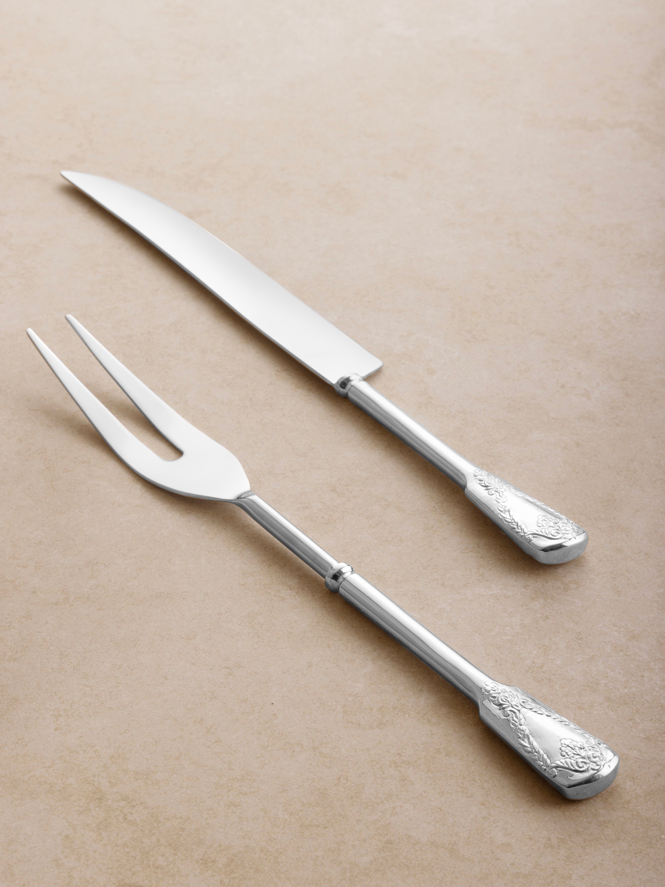 Polished silver carving utensils with embossed design — elegant tableware for entertaining