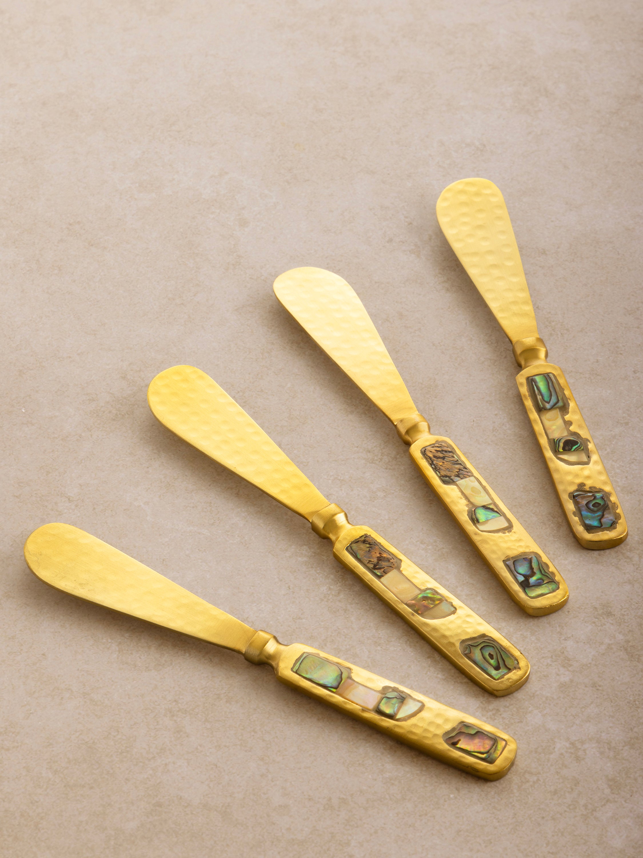 Butter knives in matte gold and mother-of-pearl detailing — refined handmade flatware set
