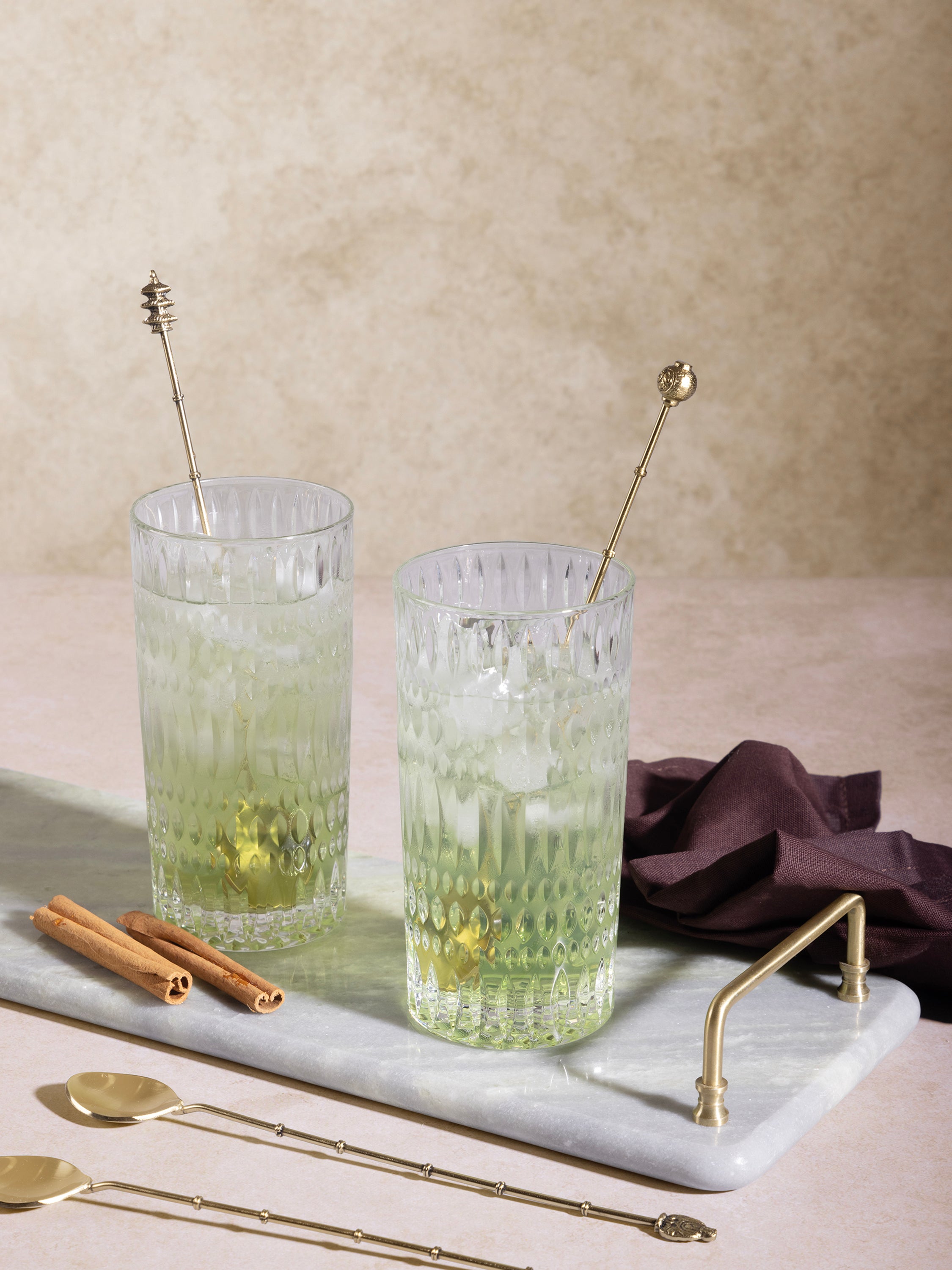 Gold-finish highball stirrers with refined handle detail — artisan barware set