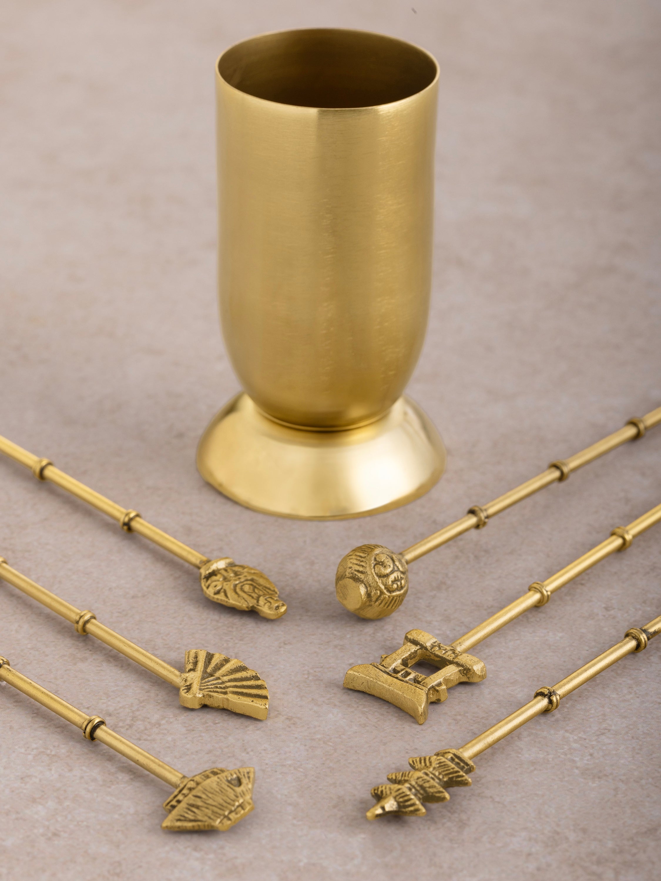 Set of luxury gold-tone cocktail picks with a matching holder