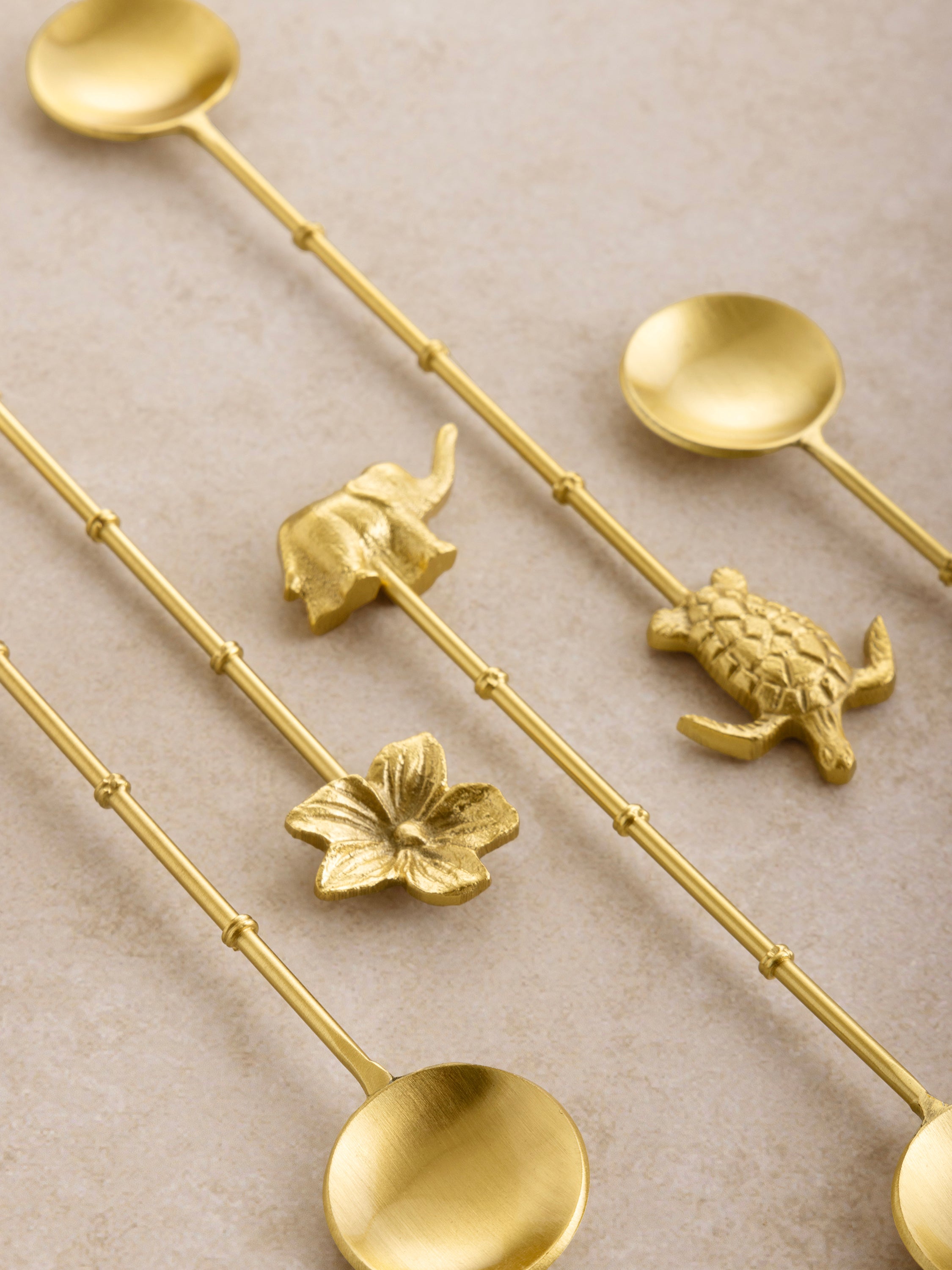Handcrafted gold teaspoons with artistic handles, ideal for stylish table settings