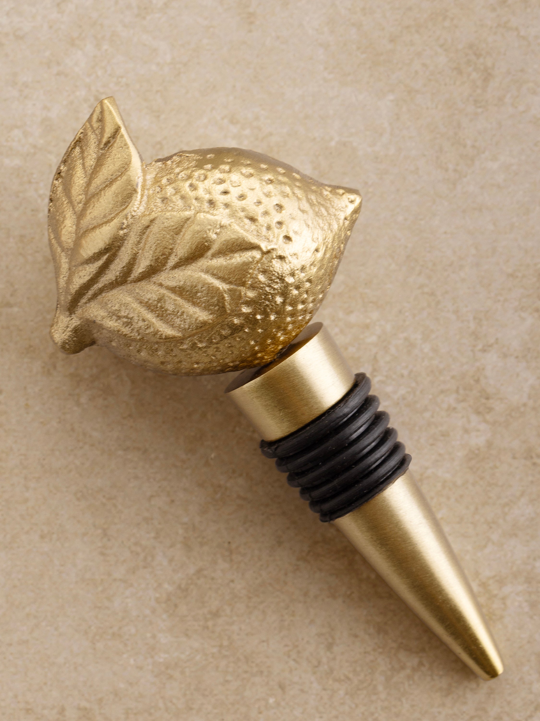 Metal wine bottle stopper with brushed gold finish — sculptural bar accessory