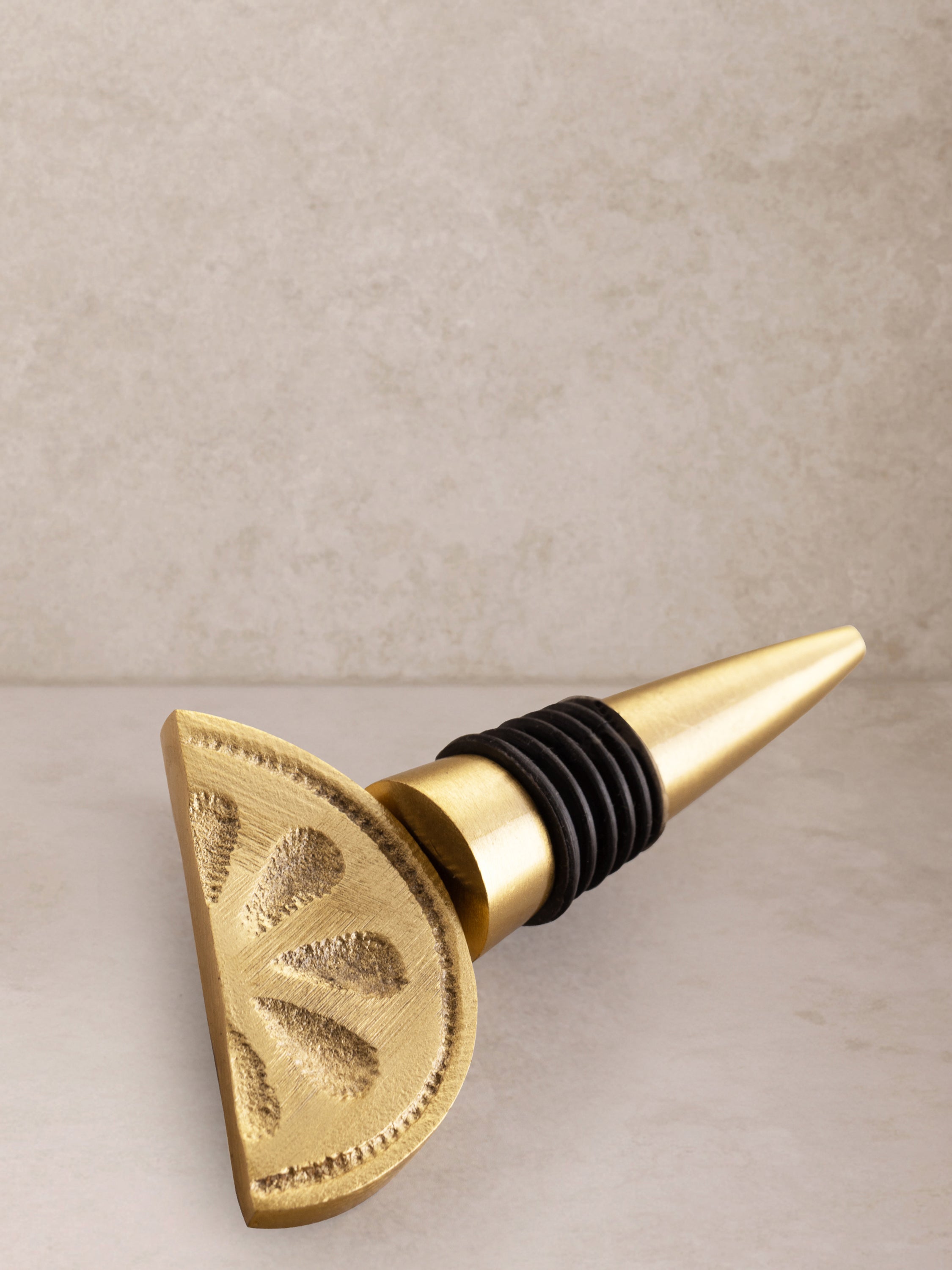 Matte-gold aluminum bottle stopper with elegant silhouette and tactile finish — handcrafted design accessory