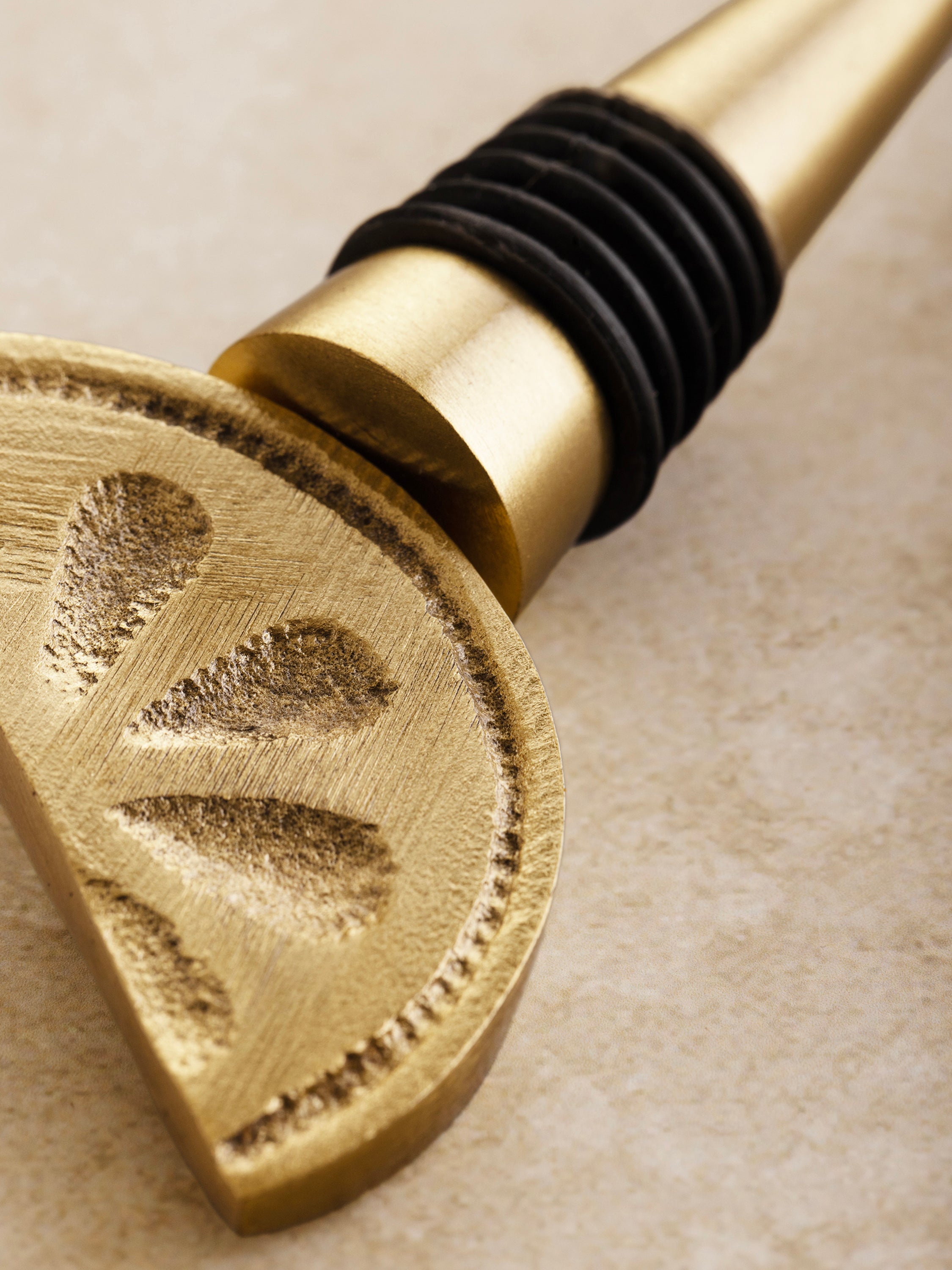 Sculptural wine bottle stopper in refined gold finish — sophisticated artisan accent