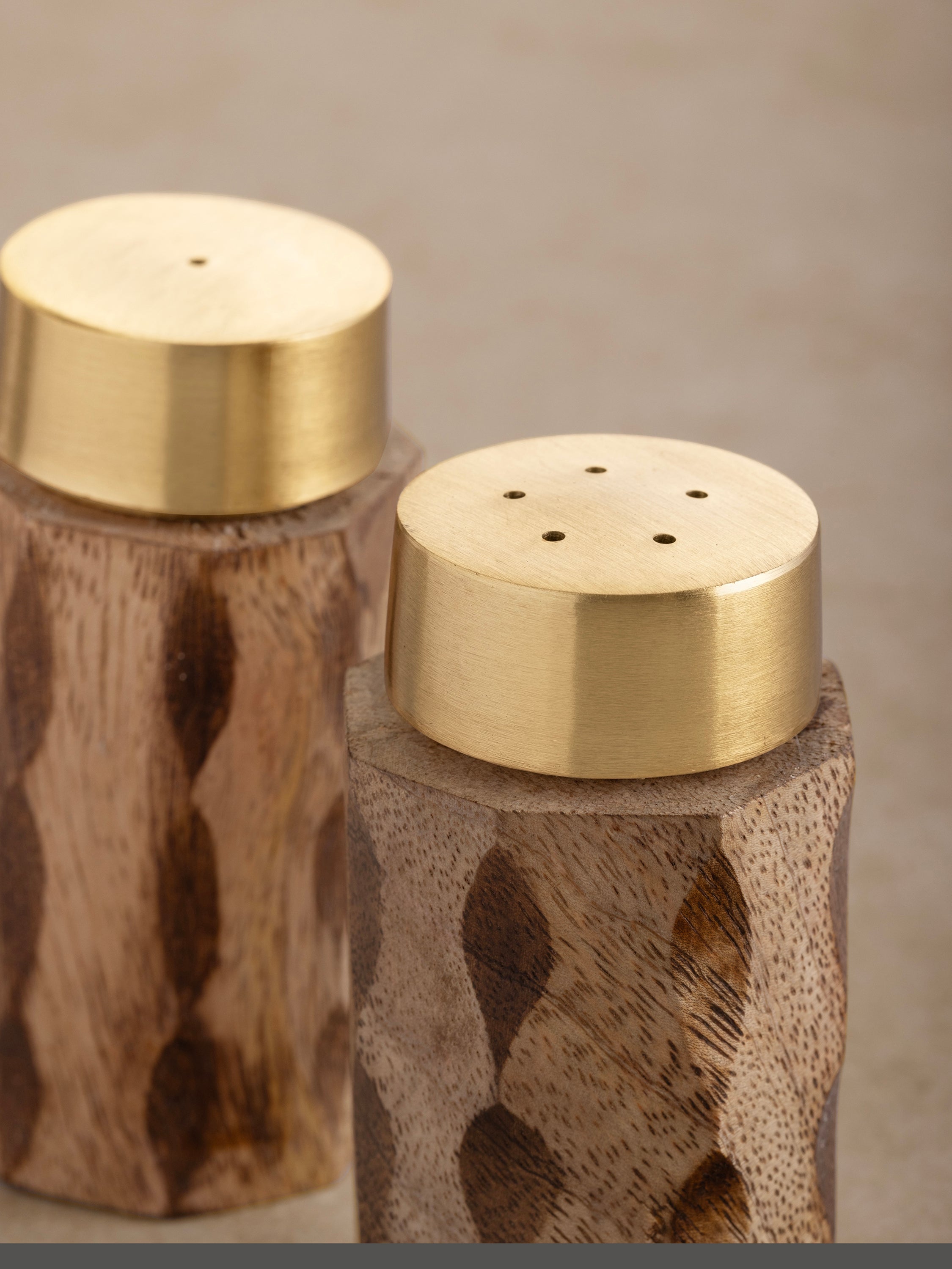 Rustic wood and brass salt & pepper shakers for a stylish dining table