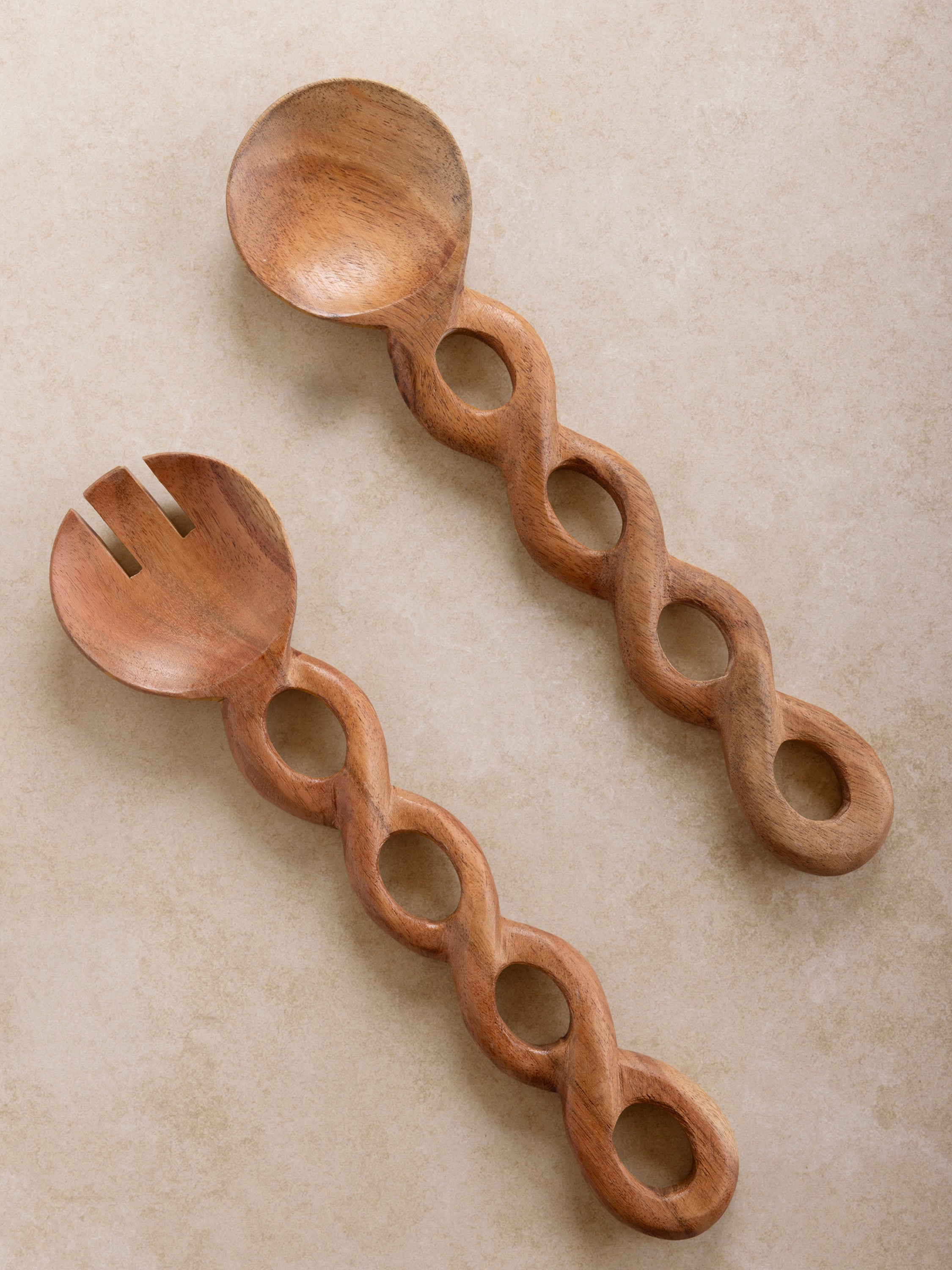 Handcrafted wooden salad server set with an elegant twisted handle design