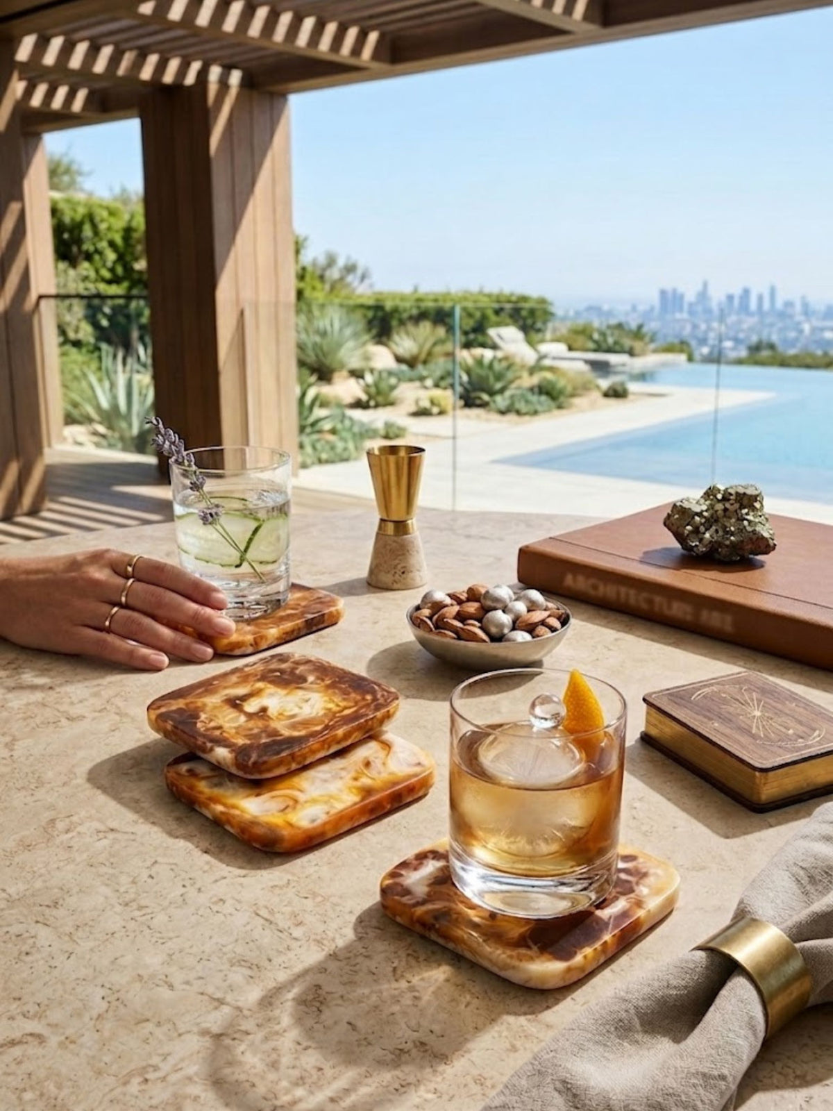 Marbled amber resin coasters shown in a rooftop bar setting with a cactus garden.