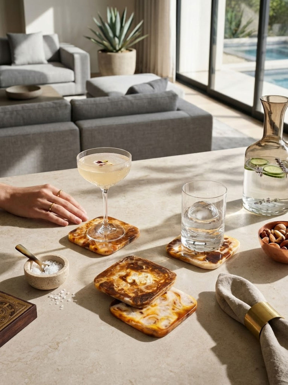 Marbled amber resin coasters shown in a living room with a poolside view.