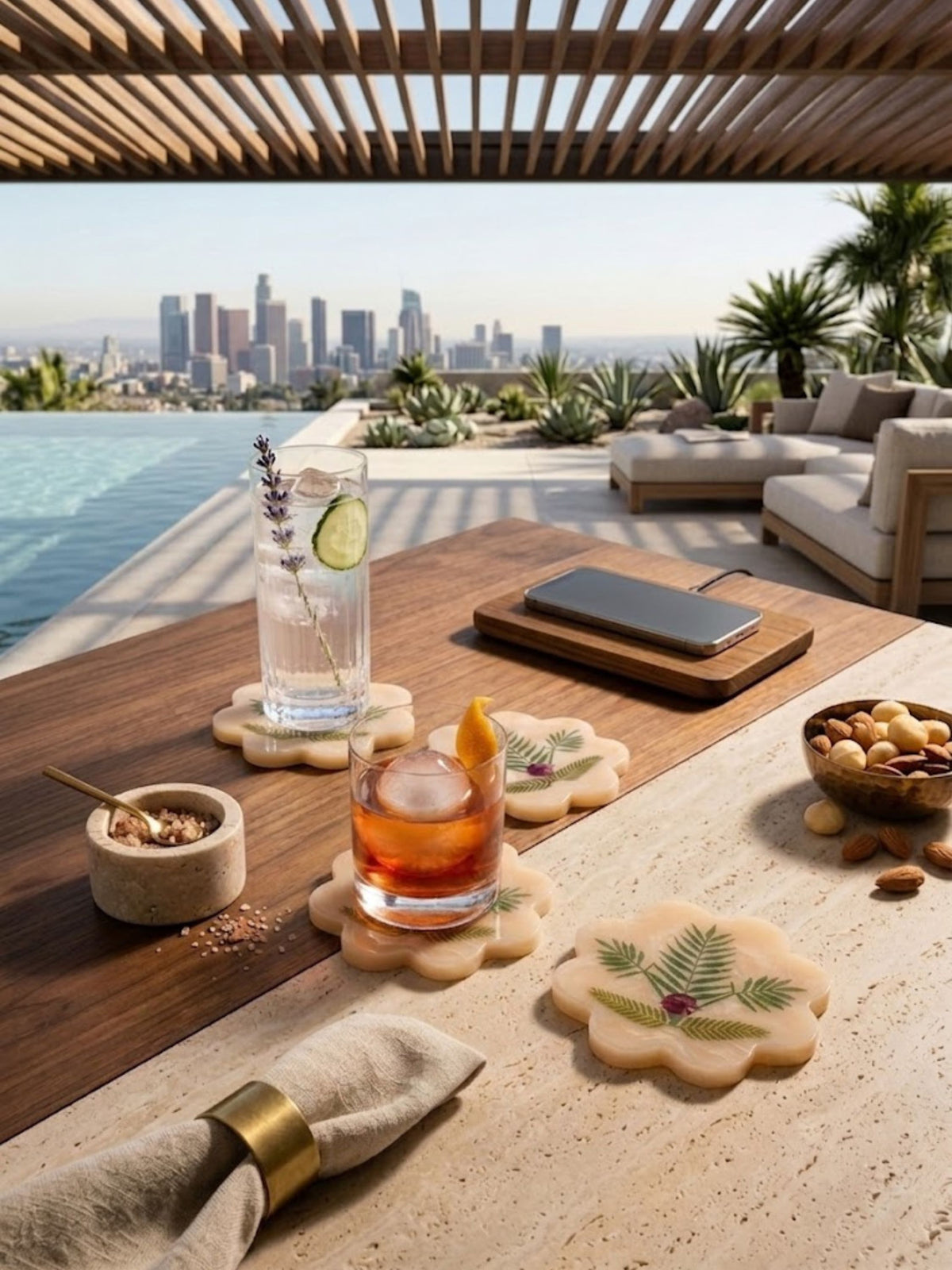 Marbled resin Trellis coasters with botanical fern motif, styled outdoors on a table.