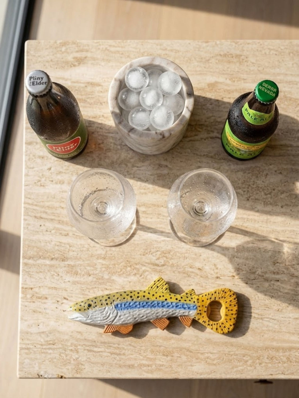Enamel fish-form bottle opener styled on a kitchen counter.