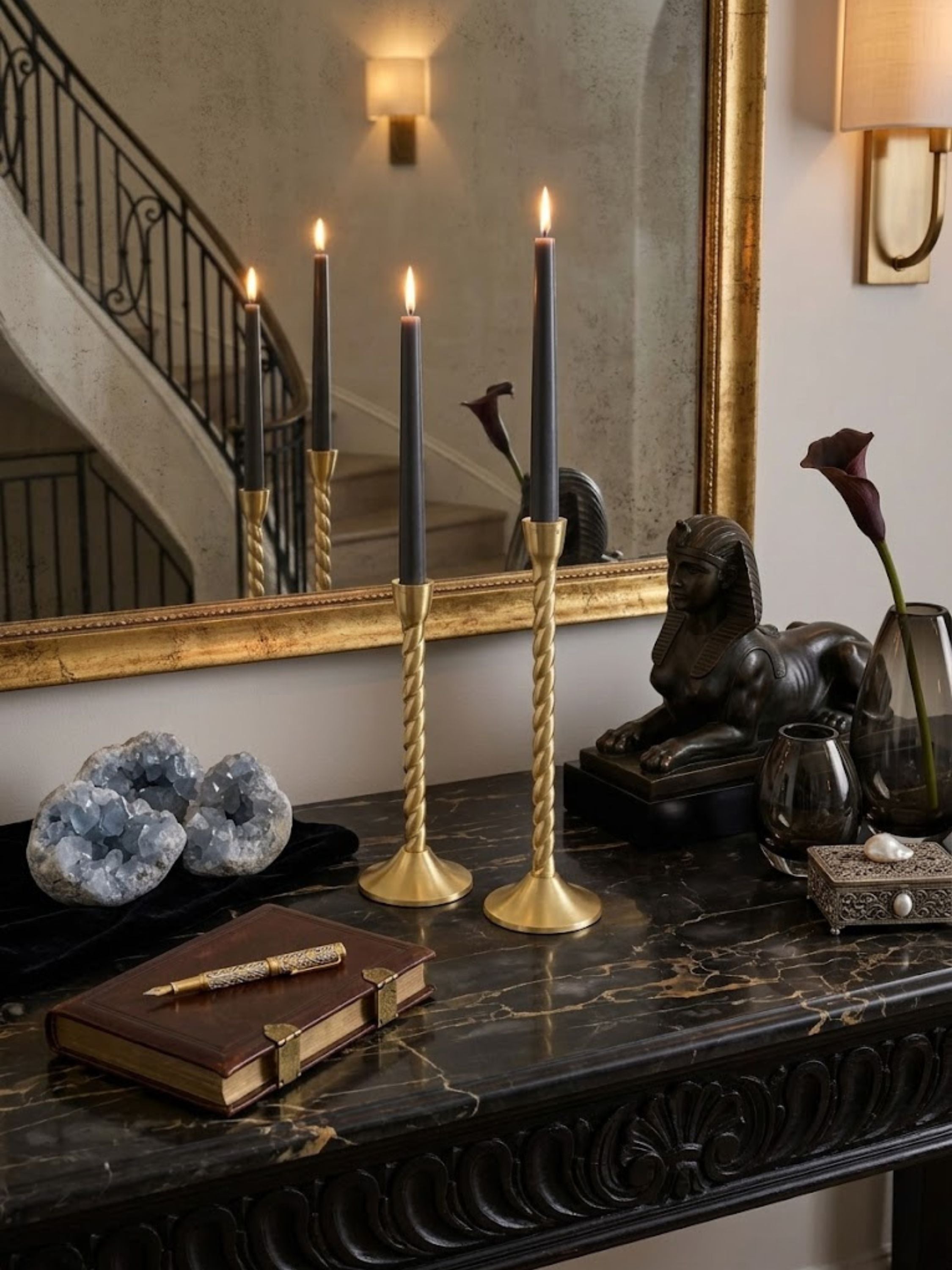 Twilight gold candle holders arranged on a library console with leather-bound books and a crystal decanter, adding warm candlelight.