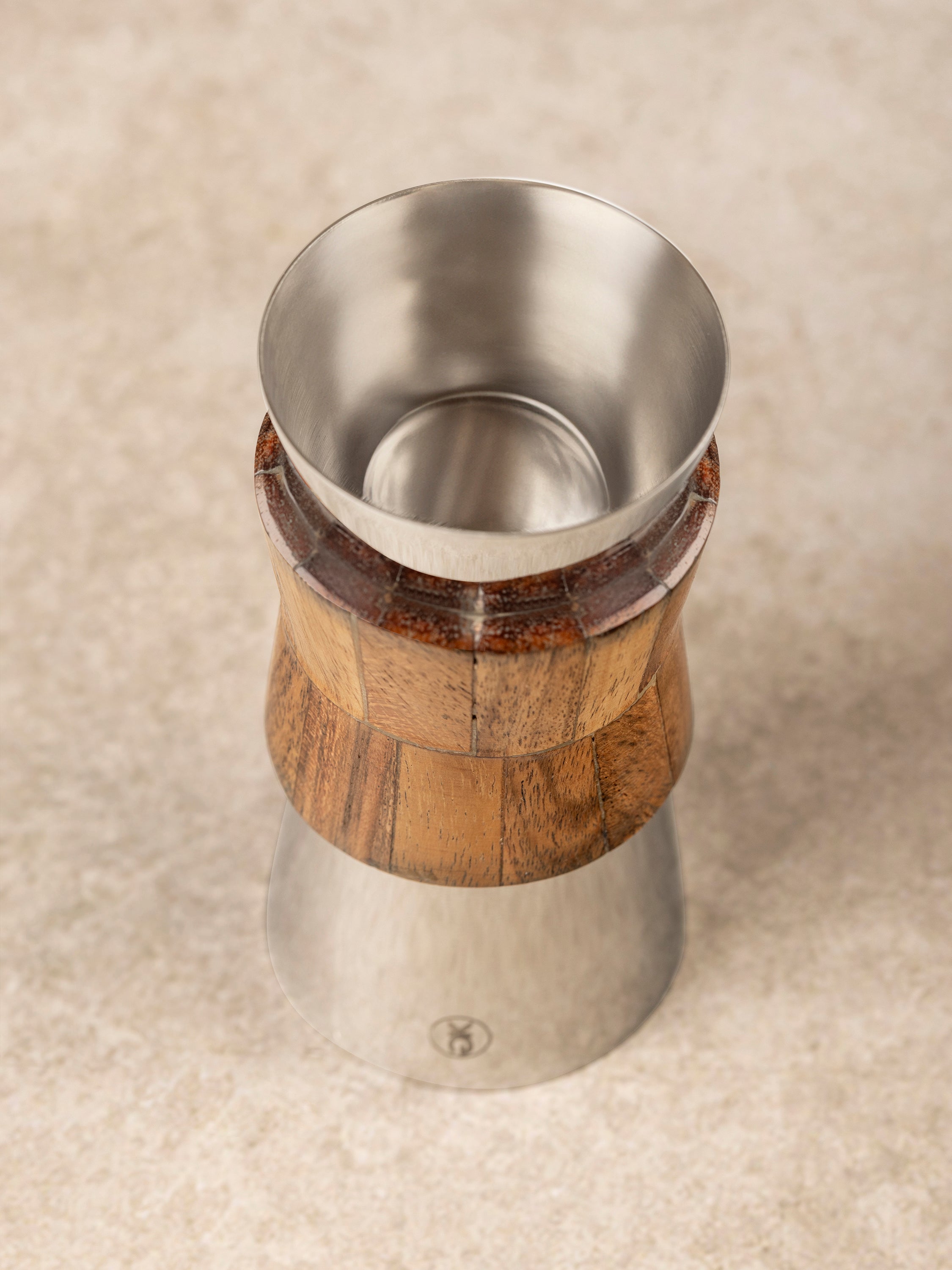 Close-up of Chicago jigger showing wood handle detailing and polished stainless steel surface