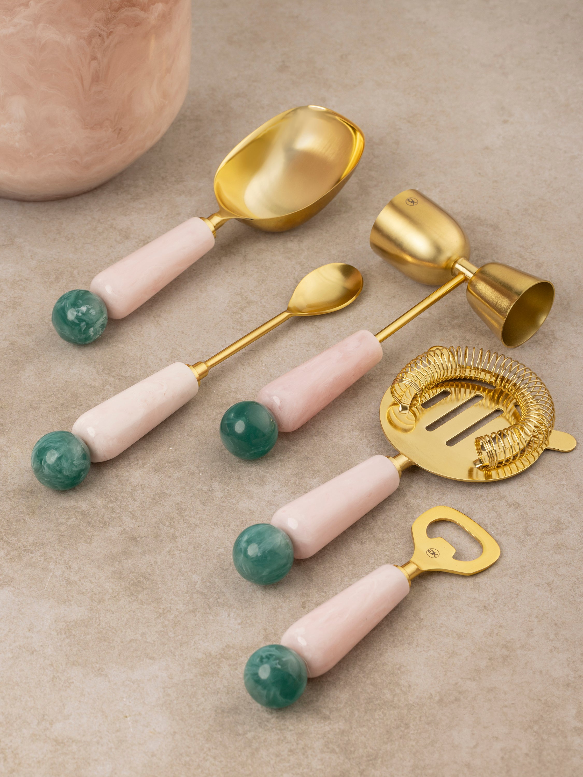 Copenhagen bar tools arranged together showing jigger, strainer, bar spoon, and muddler with resin handle detailing