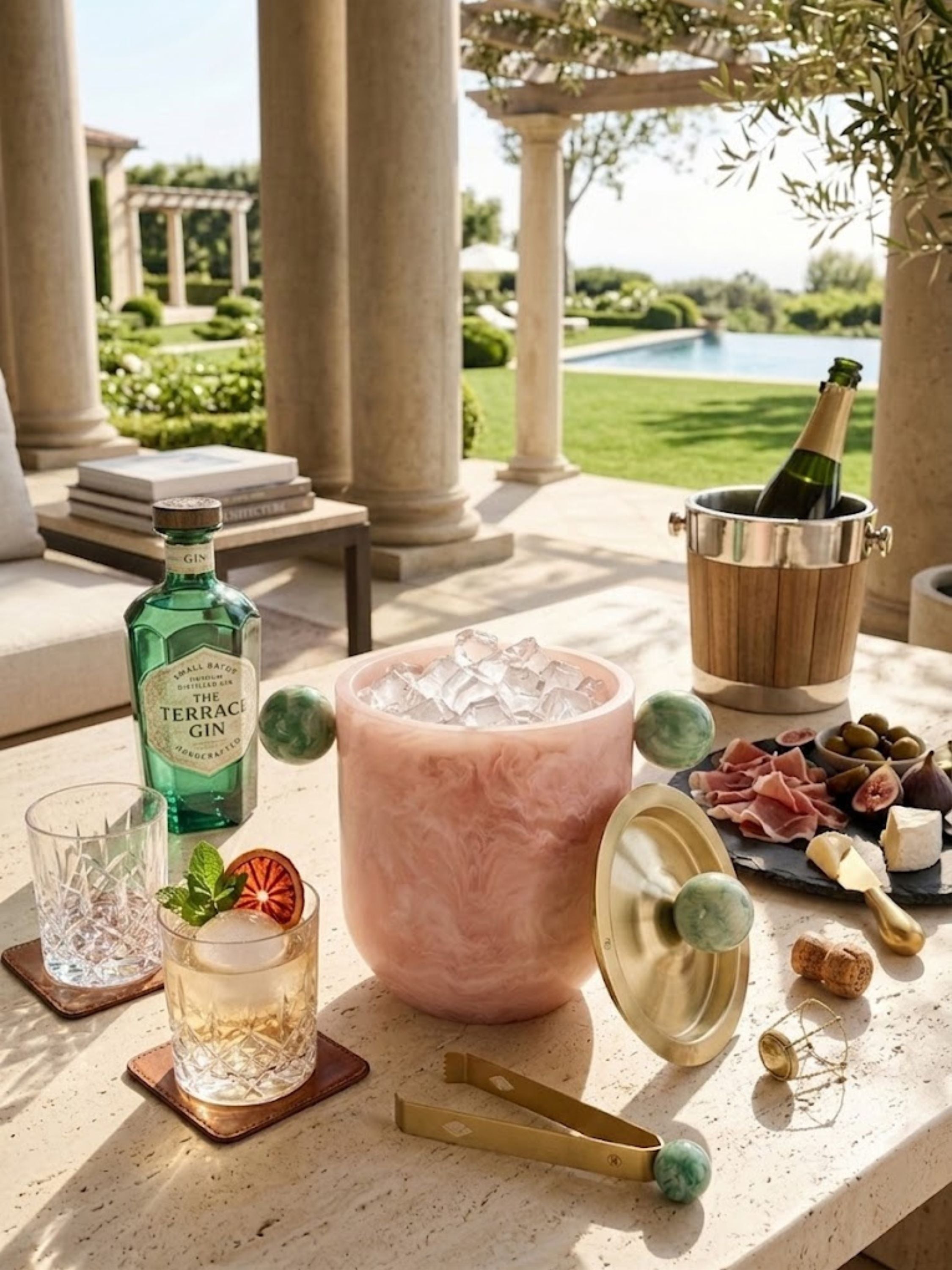 Copenhagen resin ice bucket presented on an outdoor patio table with cocktails and charcuterie, creating an elevated atmosphere for al fresco gatherings.