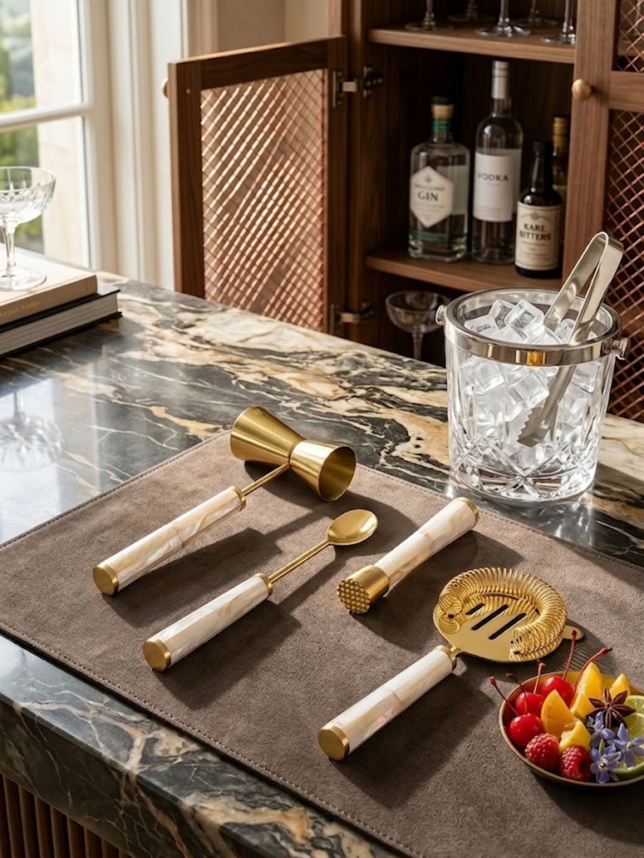 Darzi mother of pearl bar tools arranged with crystal barware and cocktail essentials, creating an inviting preparation space for refined gatherings and celebrations.