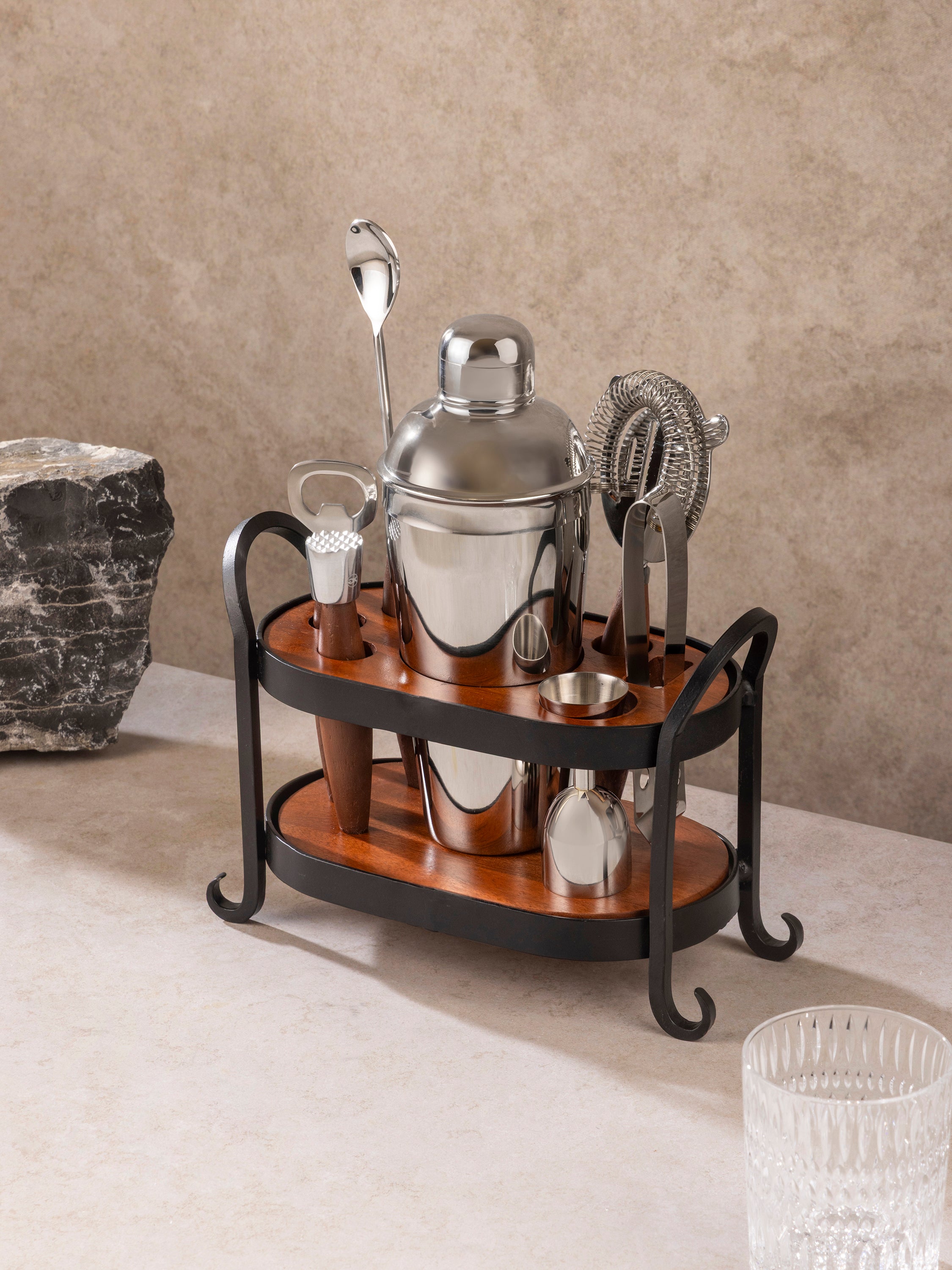 Bar tools set with stainless steel utensils, wood handles, and vertical stand shown in a clean front-facing composition
