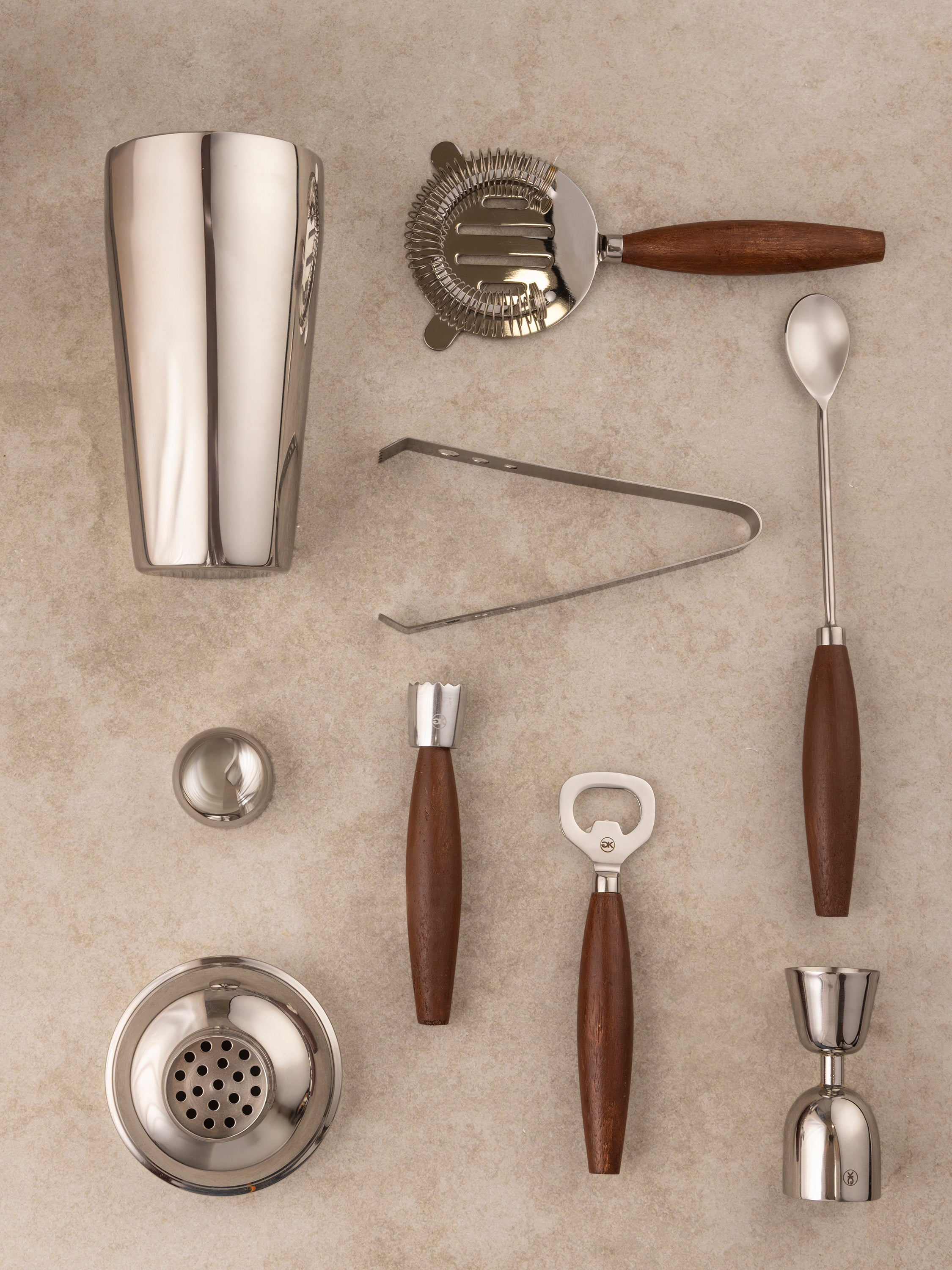 Close-up of Charley bar tool wood handle and stainless steel stem showing material contrast and refined surface finish