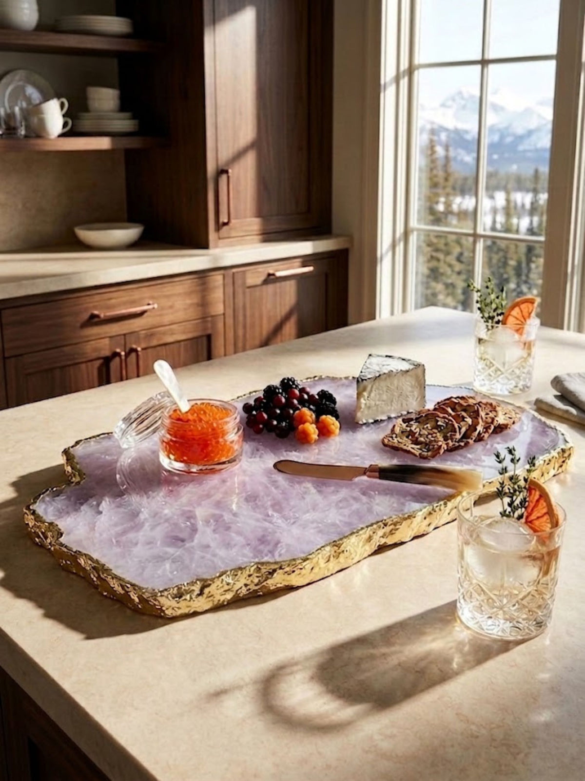 Blush-toned rose quartz stone cheese board styled on a kitchen counter.