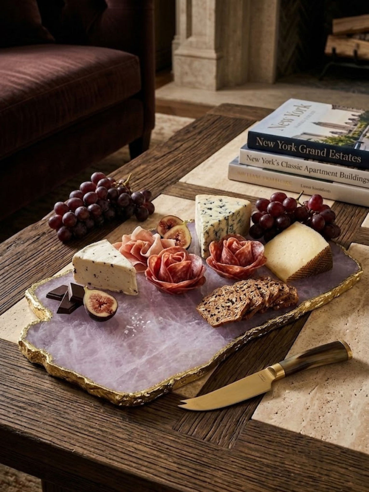 Rose quartz stone cheese board with a gold rim, styled in a living room.
