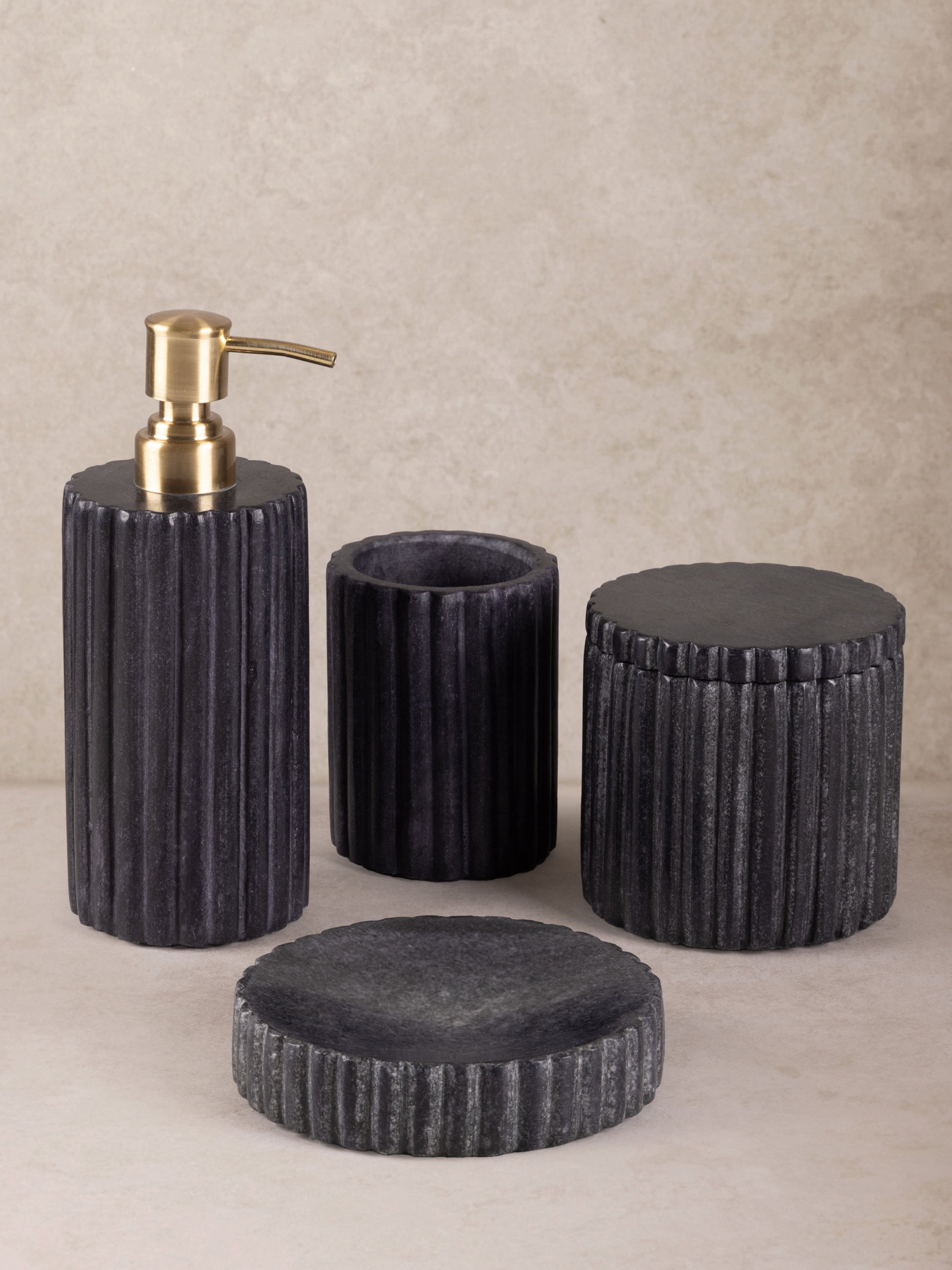 Polished natural-stone bath accessories set with smooth surfaces and inherent marble pattern — handcrafted design ensemble