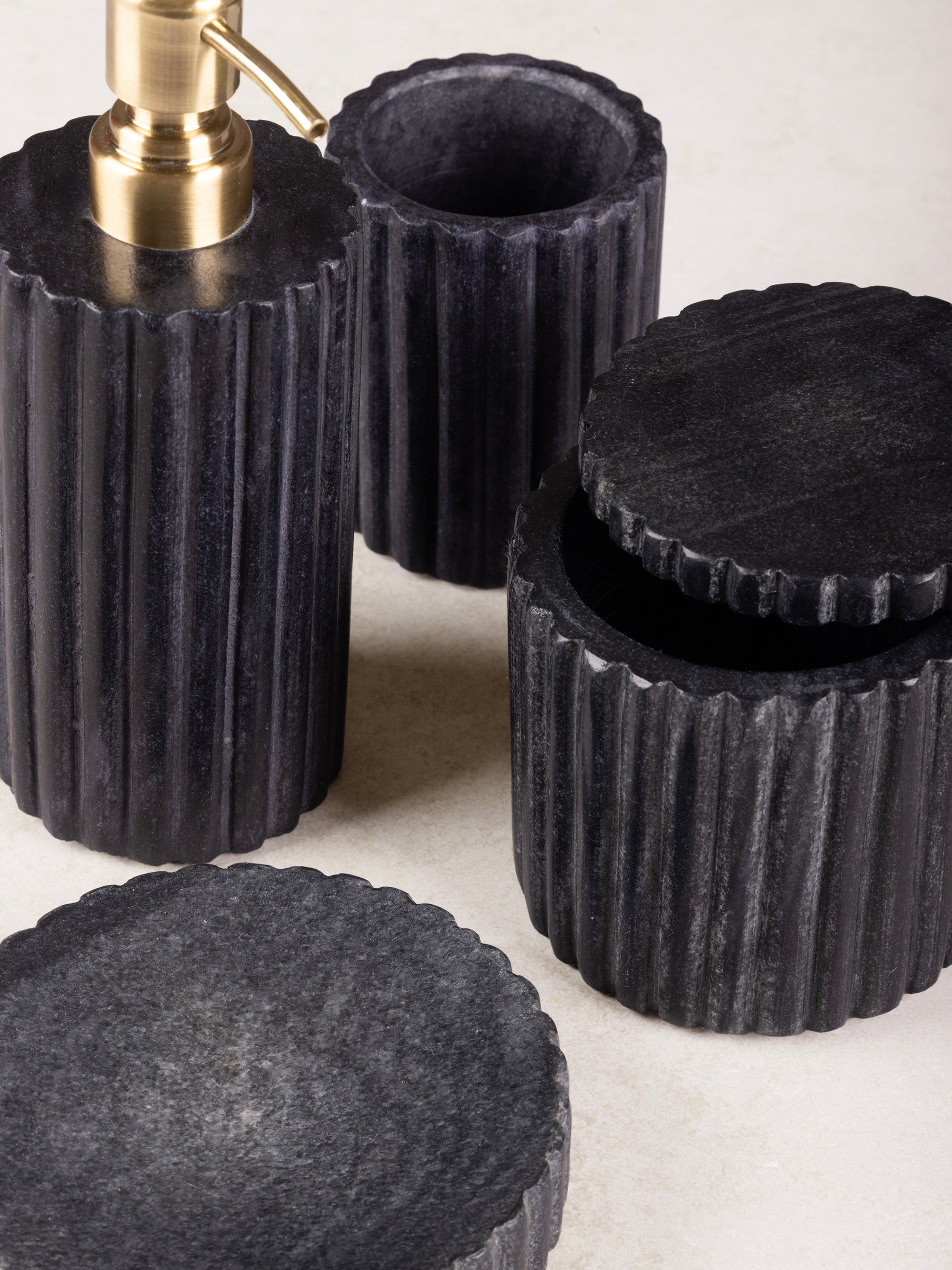 Handmade Black Marble Bath Set – Modern and Stylish Bathroom Décor
A sophisticated 4-piece black marble bath set with a fluted design, including a gold pump soap dispenser, tumbler, lidded jar, and soap tray, perfect for luxury spaces