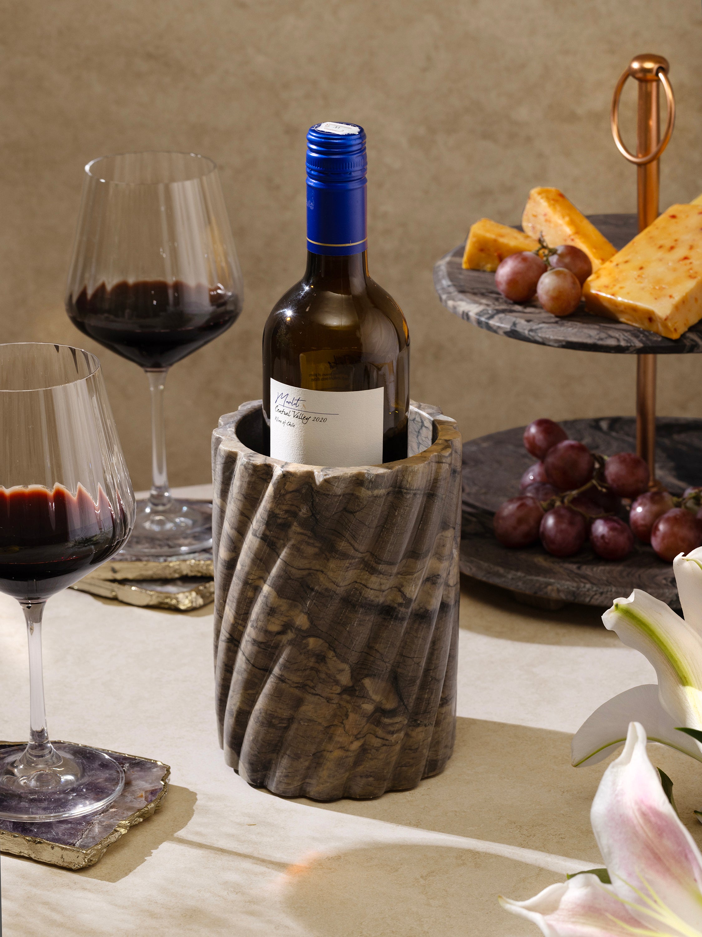 Natural stone wine cooler in ivory or brown tones with smooth veining — handcrafted design object