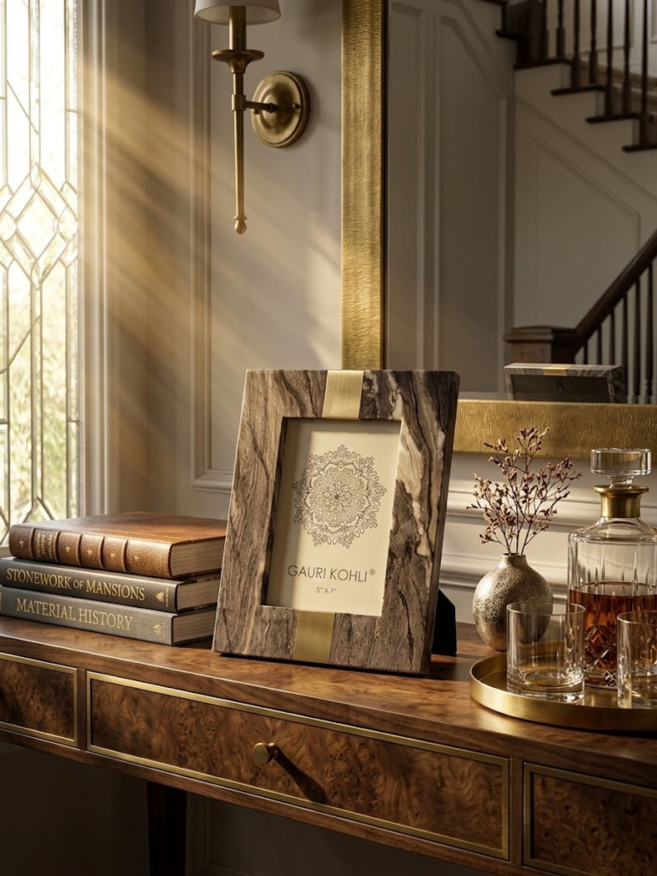 Skye brown onyx picture frame displayed on a richly detailed console table with brass accents and crystal glassware, highlighting flowing mineral veining and warm tonal depth.