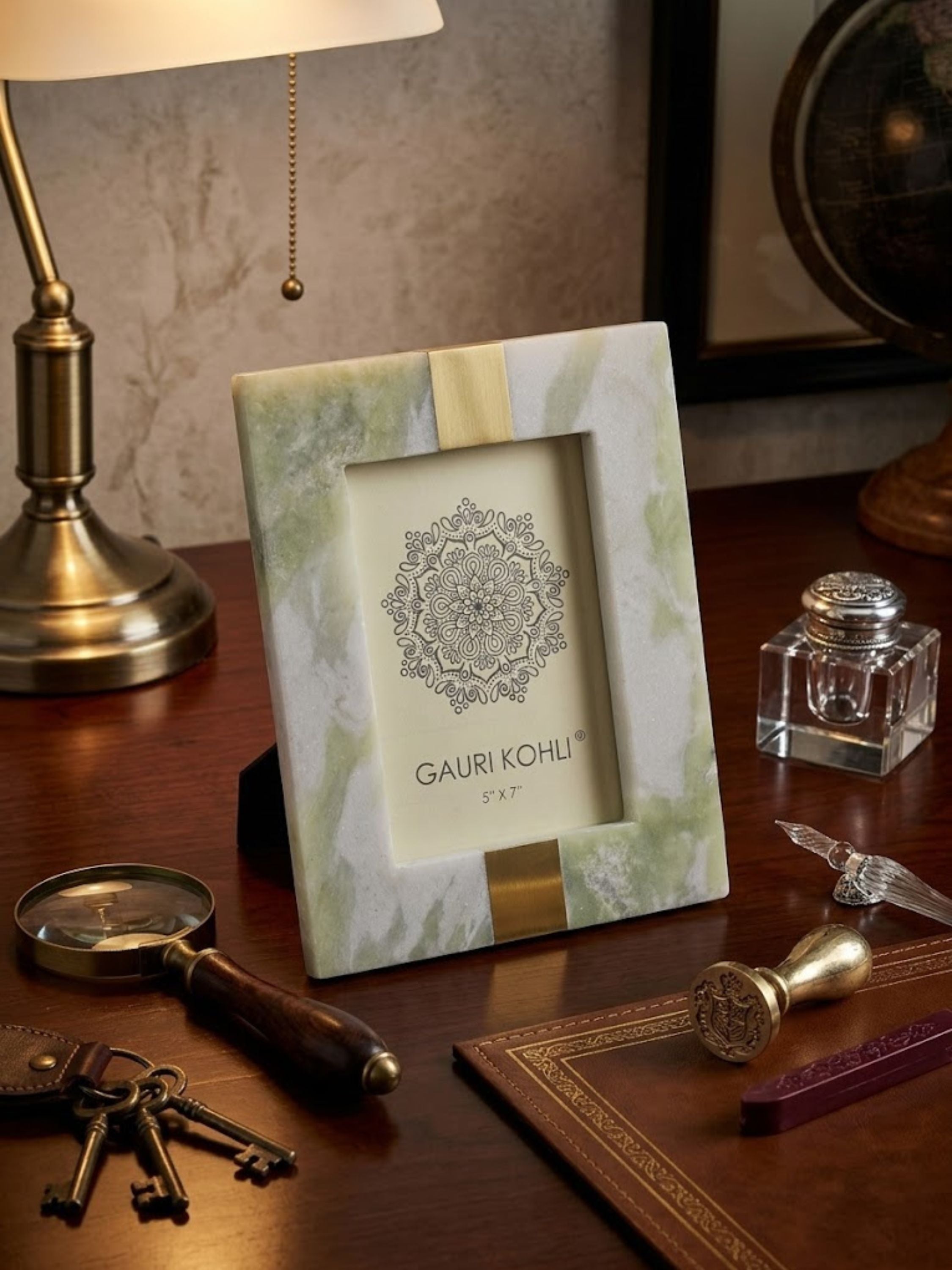 Skye green onyx picture frame displayed on a study desk alongside vintage-inspired accessories, showcasing natural stone variation and warm brass detailing.