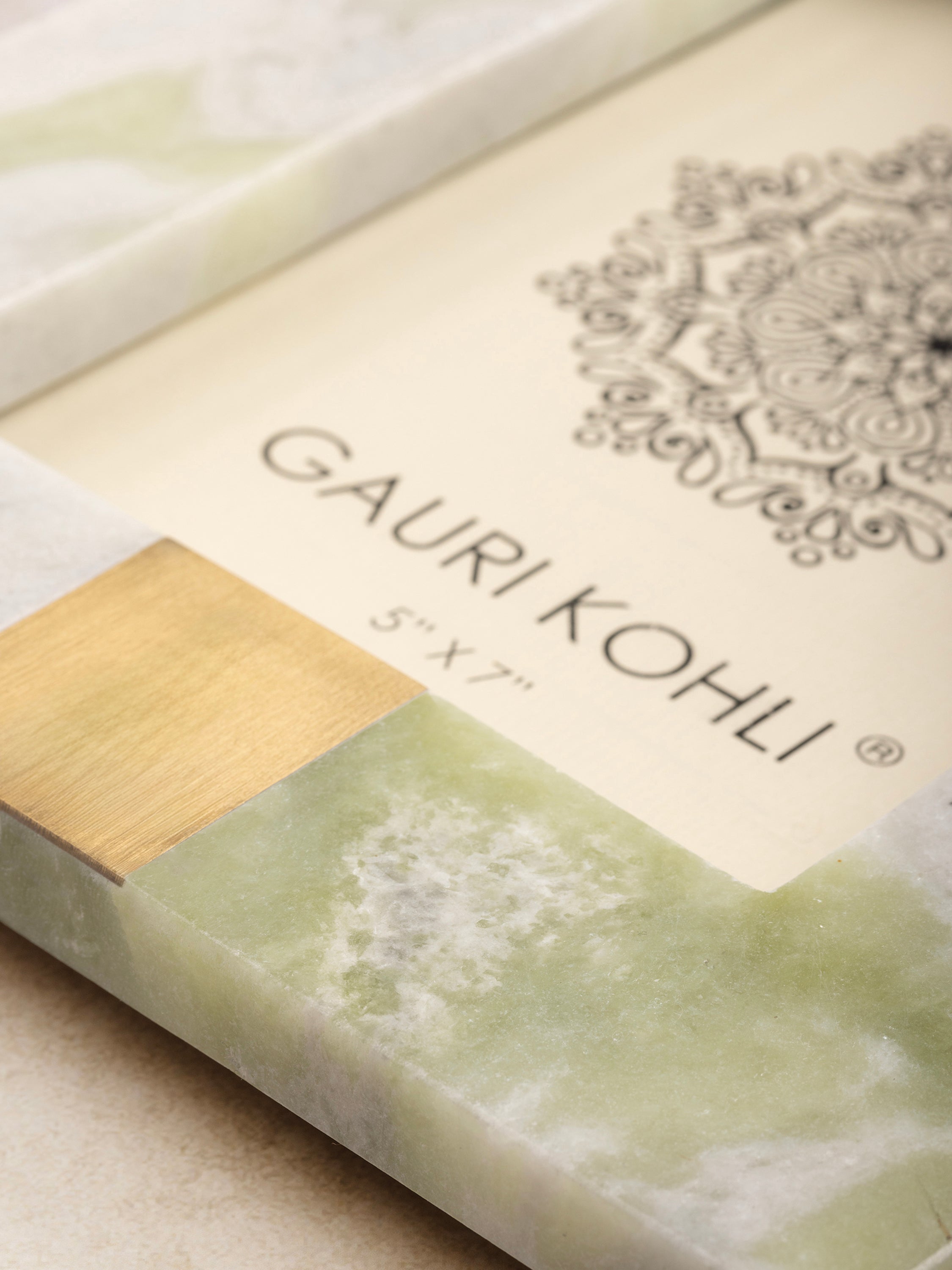 Close-up of green onyx frame showing natural veining patterns, polished finish, and brass inlay detail