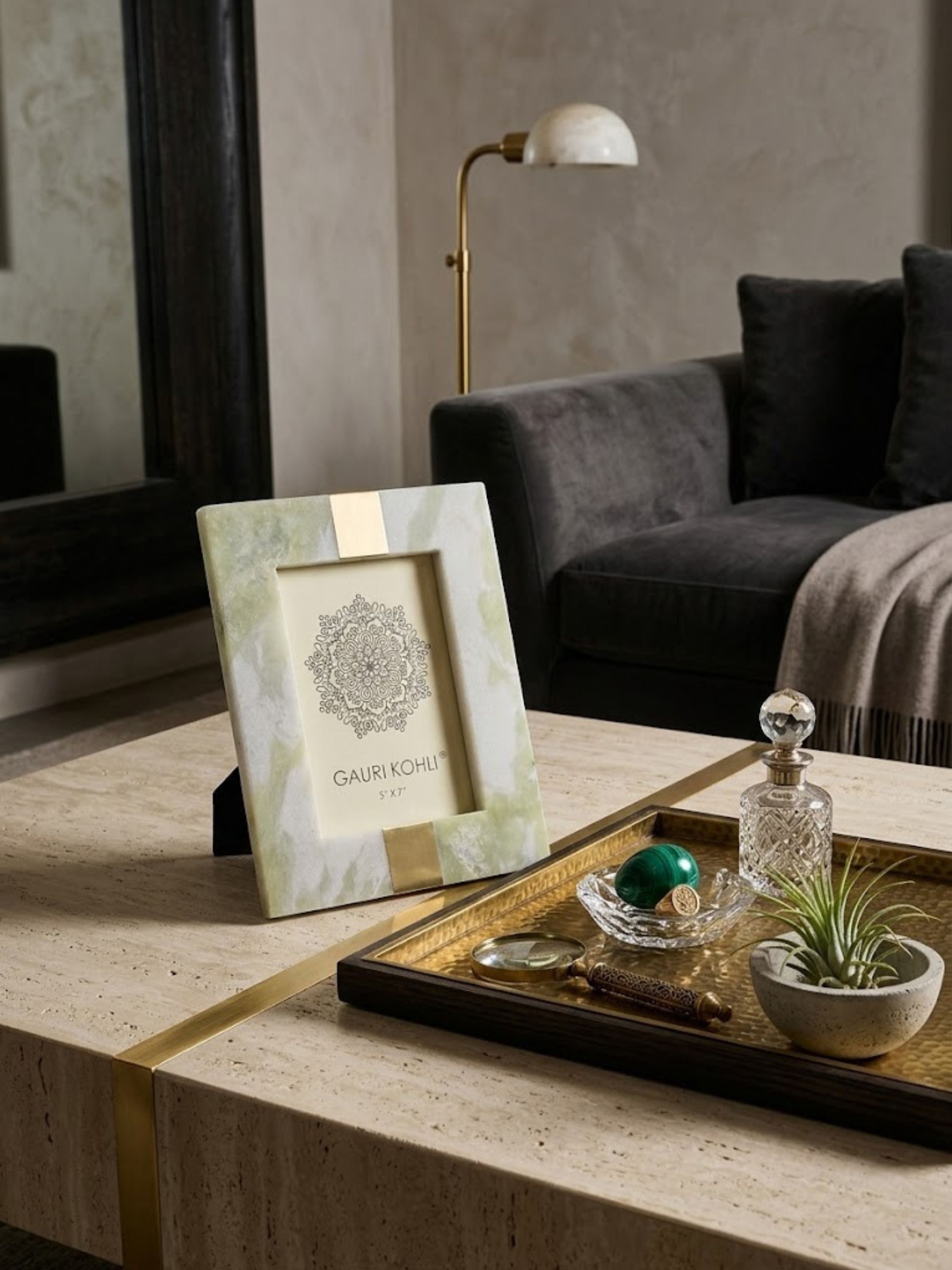 Skye green onyx picture frame displayed on a travertine coffee table with curated decorative objects, showcasing soft mineral character and timeless sculptural presence.