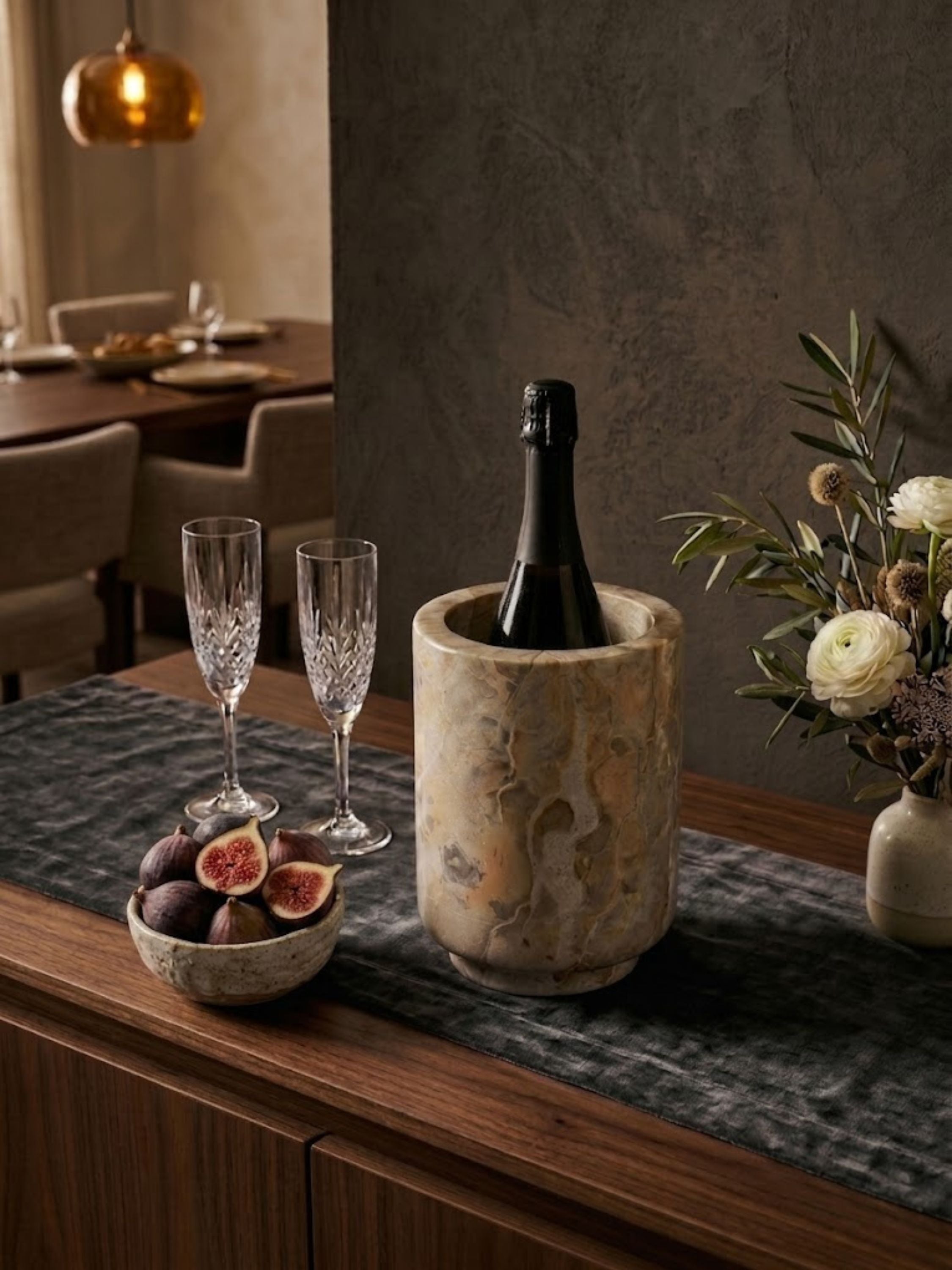 Chamonix brown onyx wine cooler displayed on a bar cart beside champagne flutes and a spirits collection.