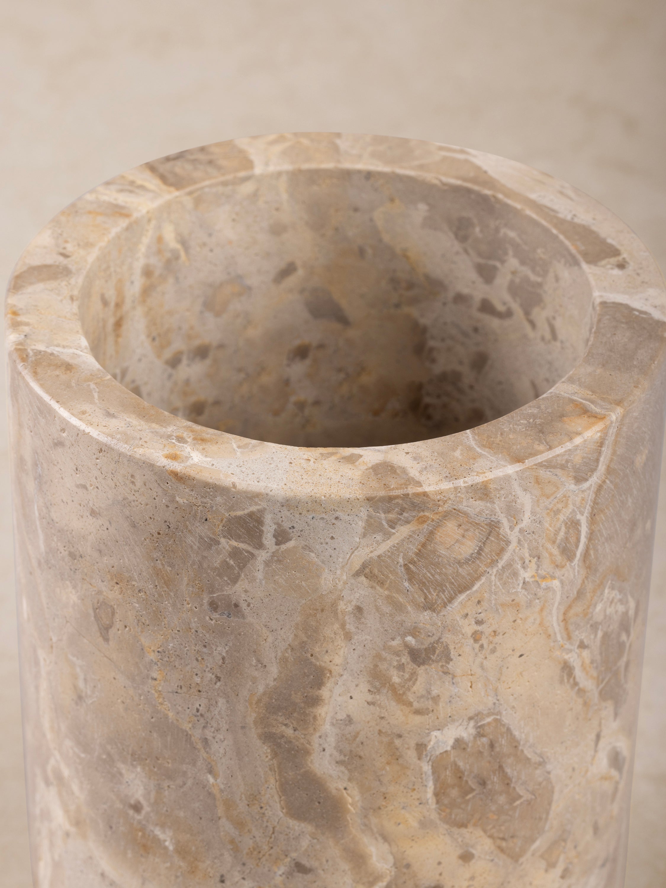 Close-up of the Chamonix cooler's beige onyx interior, showing its smooth surface, rounded rim, and layered veining.