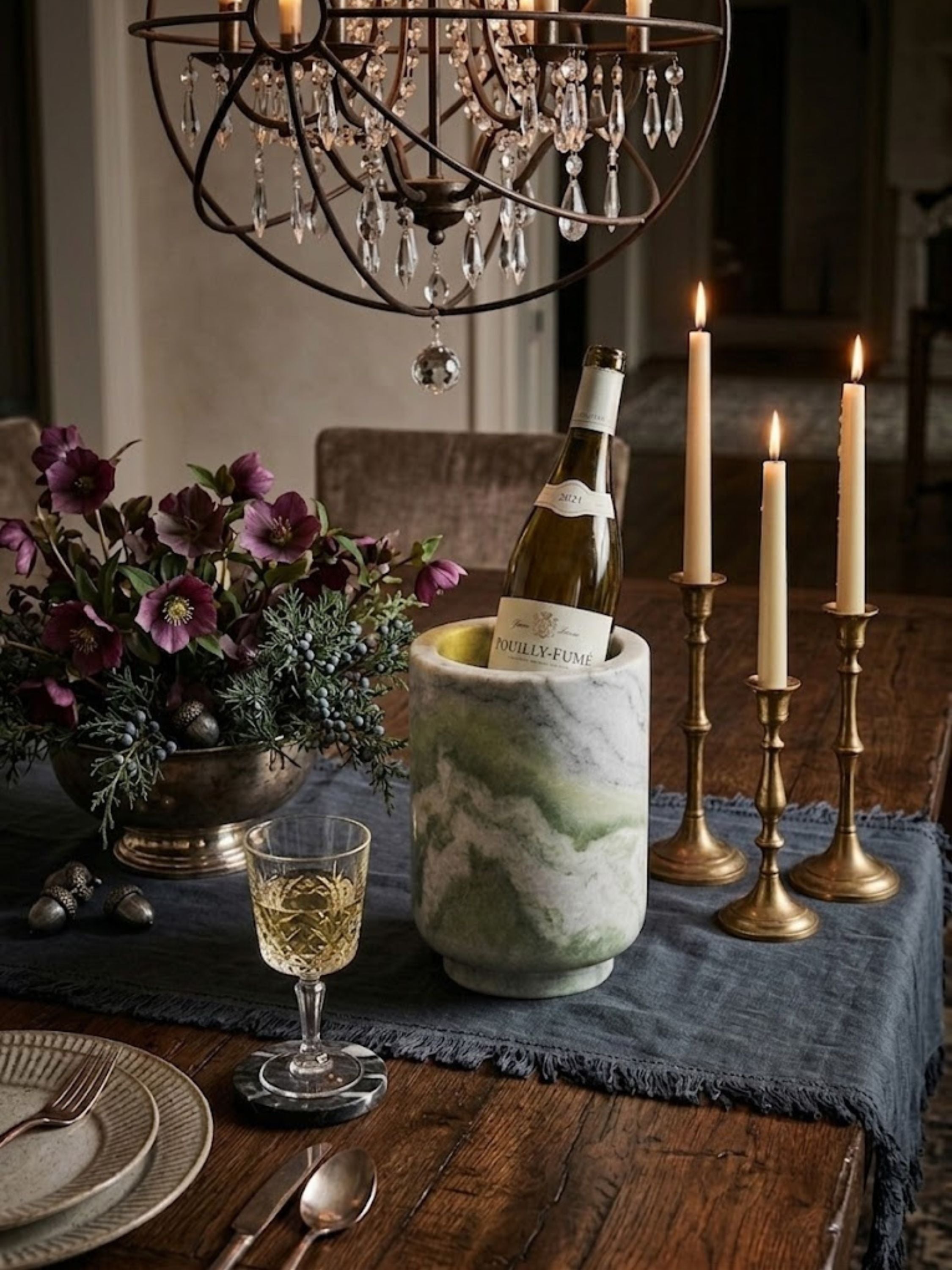 Chamonix green onyx wine cooler arranged on a candlelit dining table with floral accents and crystal stemware.