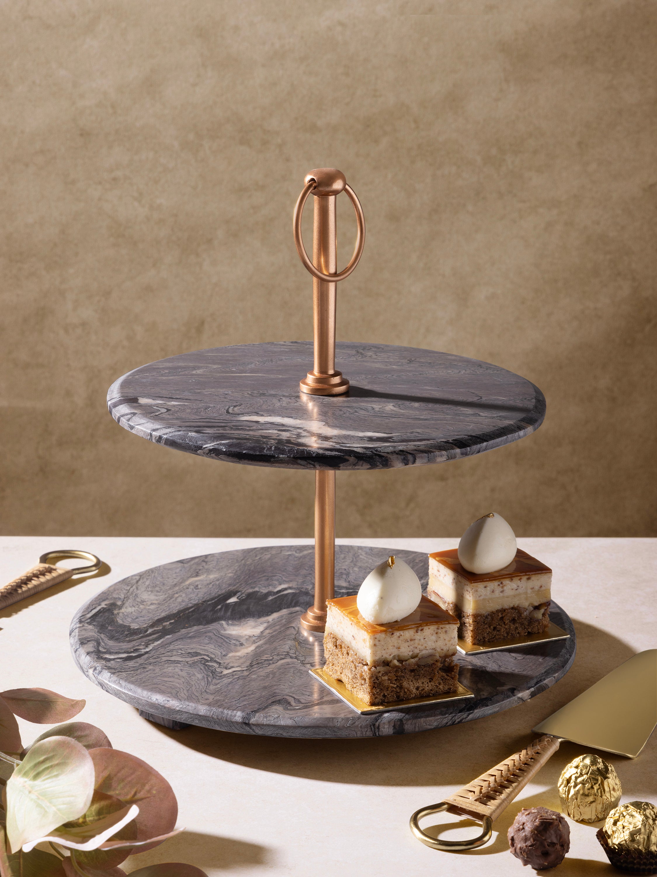 Brown Onyx Marble stand displaying assorted cakes and pastries
