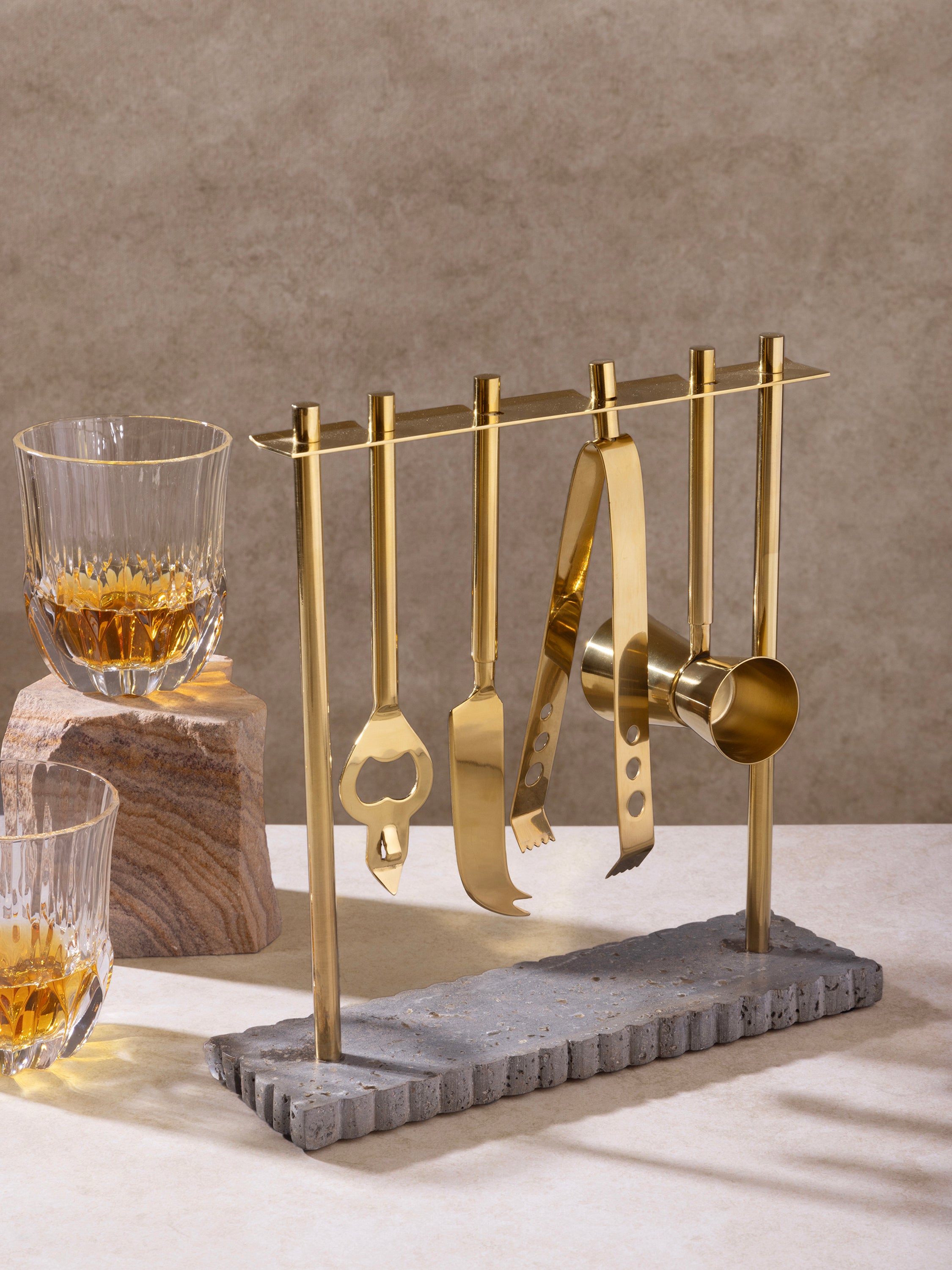 Barware set styled on countertop with cocktail elements